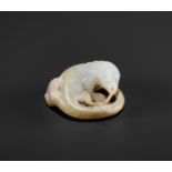 AN ARCHAISTIC WHITE AND RUSSET JADE FIGURE OF A LIZARD, QING