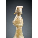 AN ARCHAISTIC CELADON JADE FIGURE OF A STANDING LADY