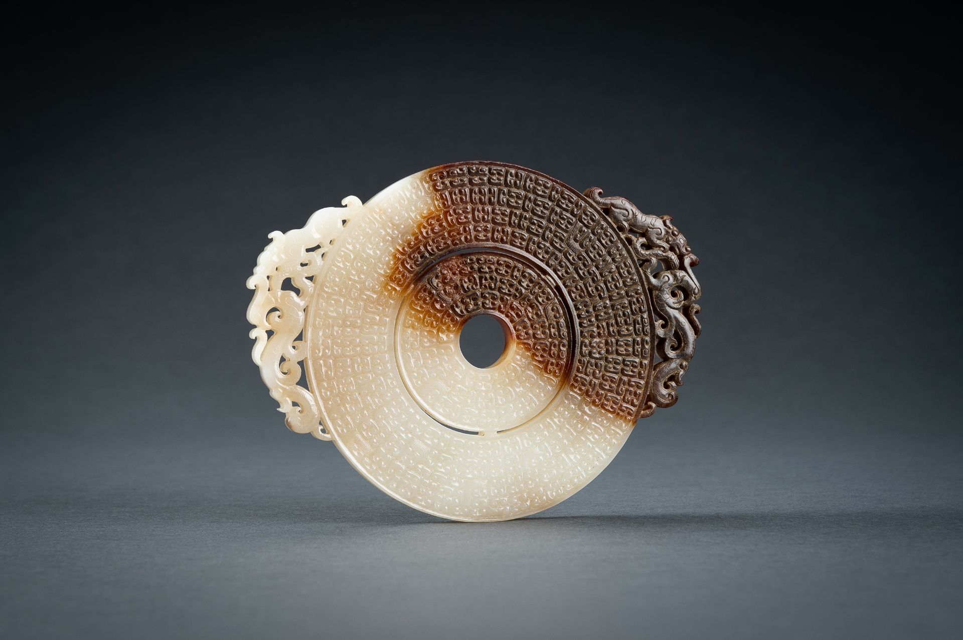 AN ARCHAISTIC WHITE AND BROWN JADE DOUBLE BI DISC, QING - Image 2 of 15