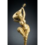 AN ARCHAISTIC FIRE-GILT COPPER REPOUSSÃ‰ FIGURE OF A SEMI-NUDE FEMALE MUSICIAN