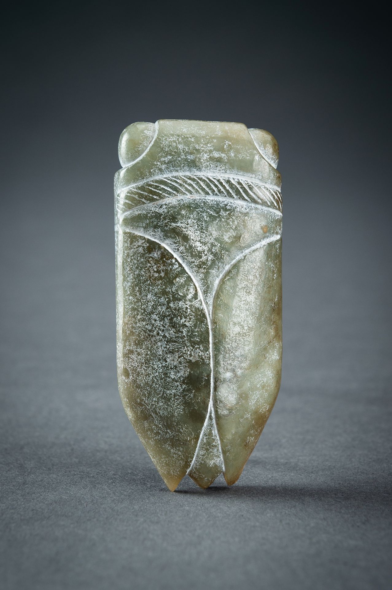 AN ARCHAISTIC GREEN JADE PENDANT OF A CICADA