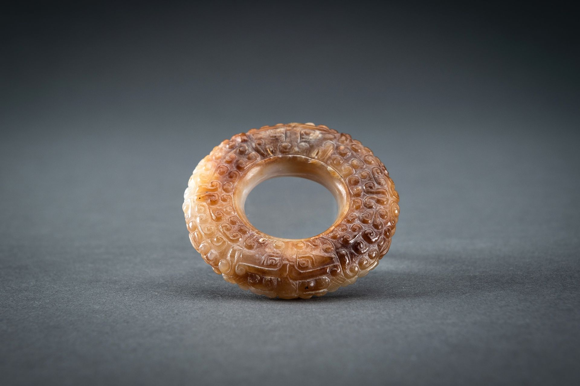 A WHITE AND RUSSET JADE 'CURLS AND TAOTIE MASKS' RING, HUAN, QING - Image 19 of 19
