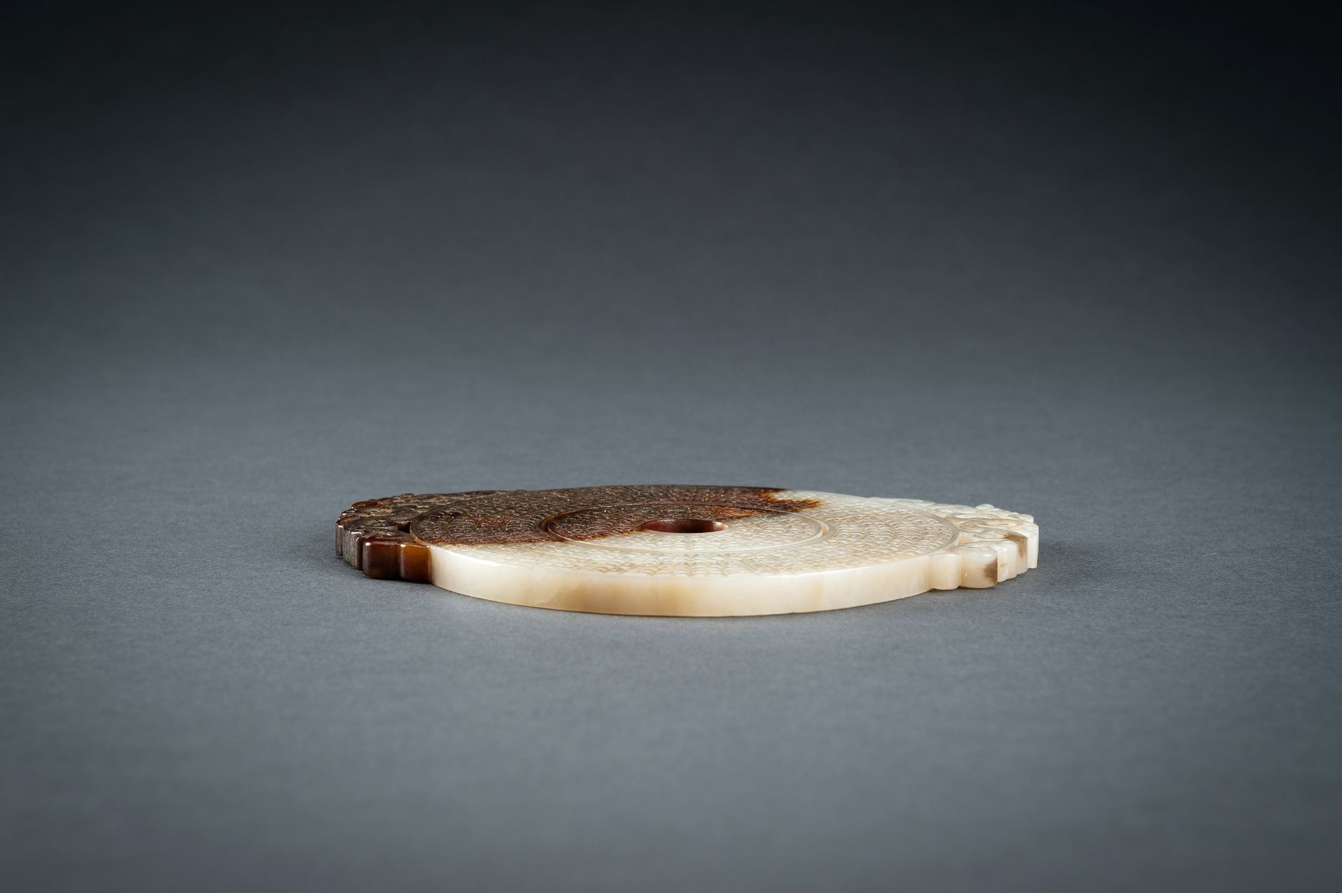 AN ARCHAISTIC WHITE AND BROWN JADE DOUBLE BI DISC, QING - Image 14 of 15