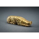 AN ARCHAISTIC FIRE-GILT COPPER REPOUSSÃ‰ FIGURE OF A RECLINING PIG