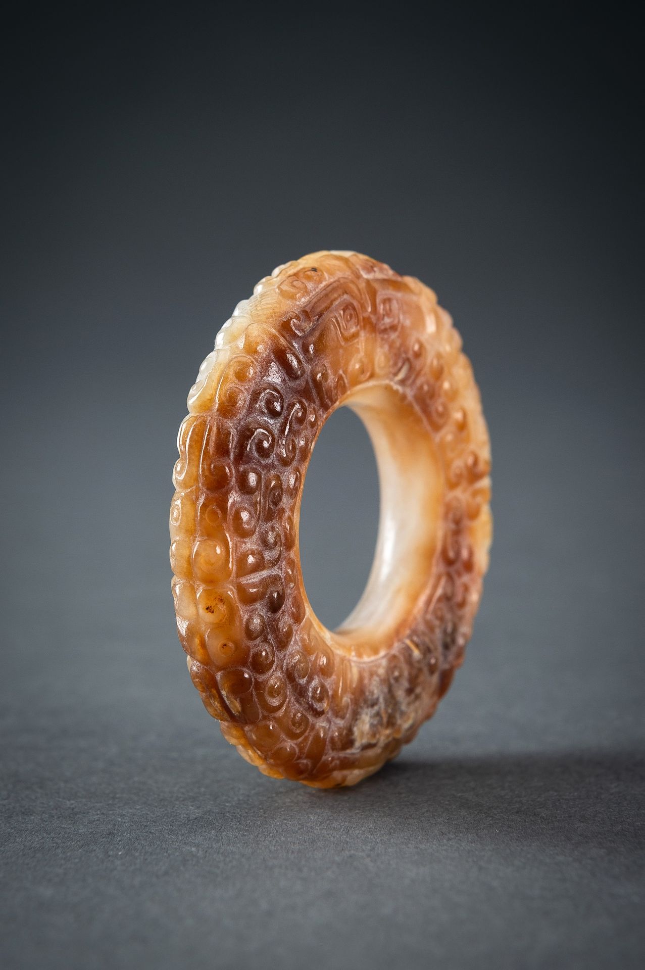 A WHITE AND RUSSET JADE 'CURLS AND TAOTIE MASKS' RING, HUAN, QING - Image 9 of 19