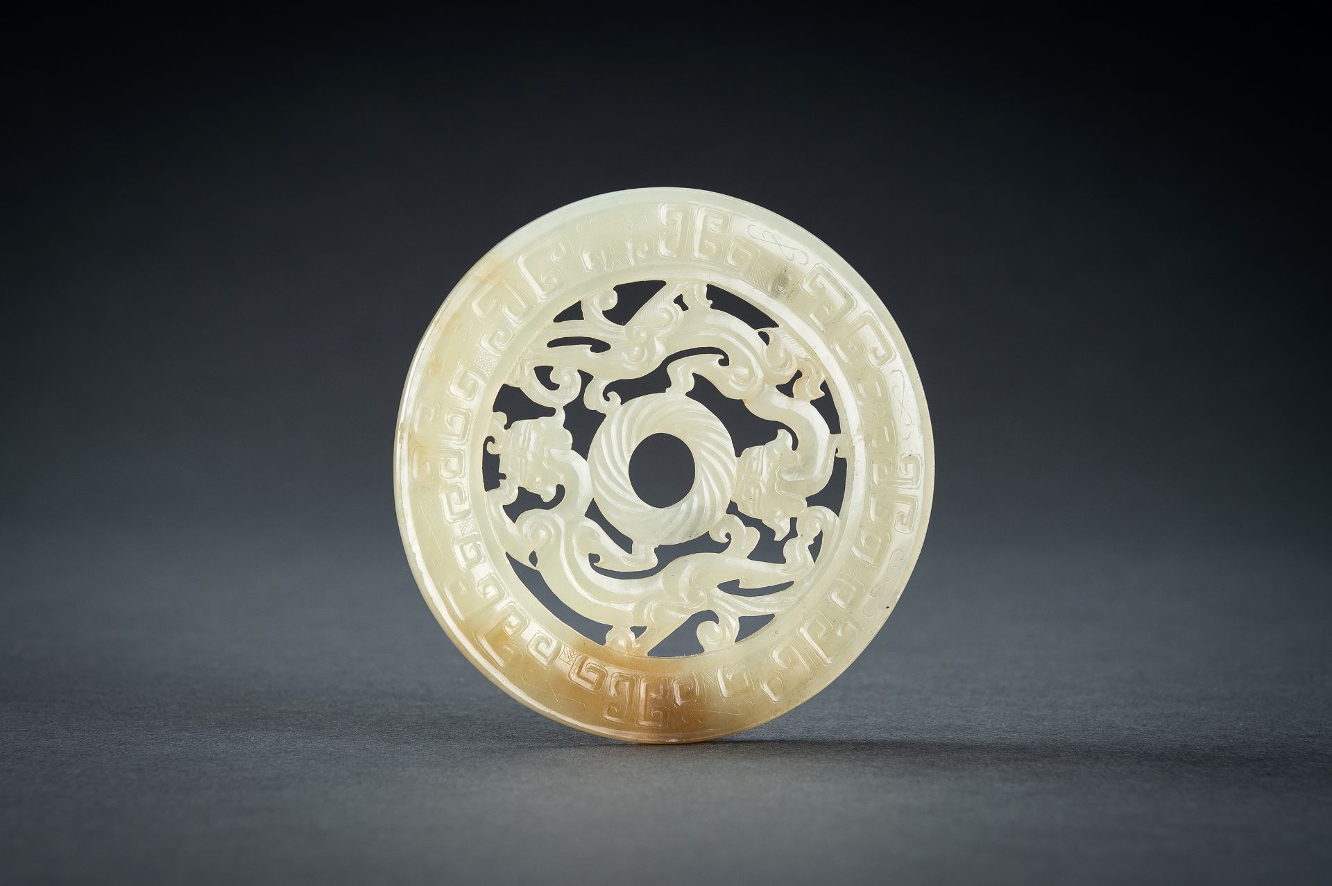 AN ARCHAISTIC YELLOW JADE RETICULATED 'CHILONG' BI DISC, QING - Image 4 of 15