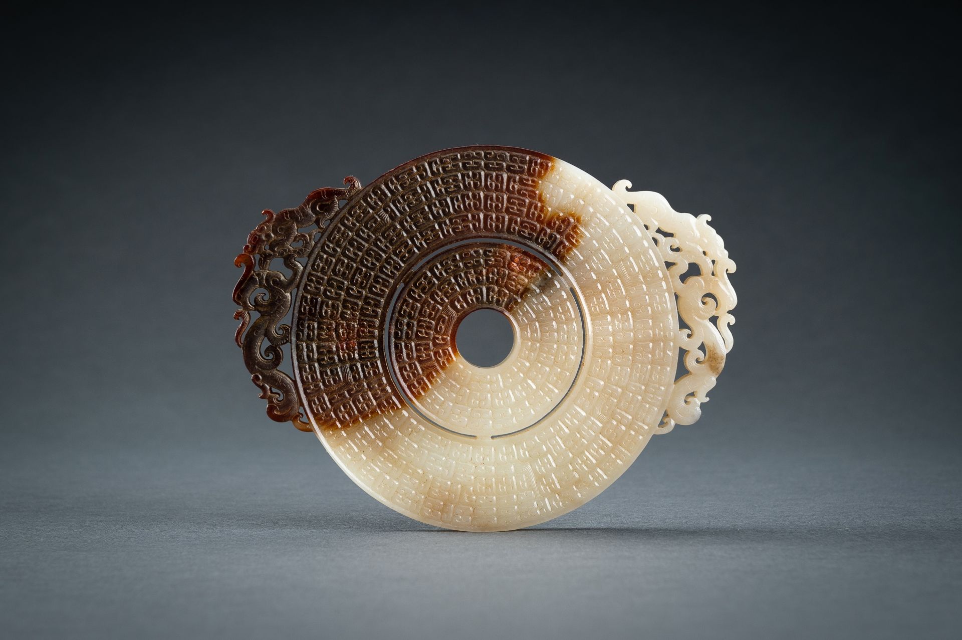 AN ARCHAISTIC WHITE AND BROWN JADE DOUBLE BI DISC, QING - Image 7 of 15