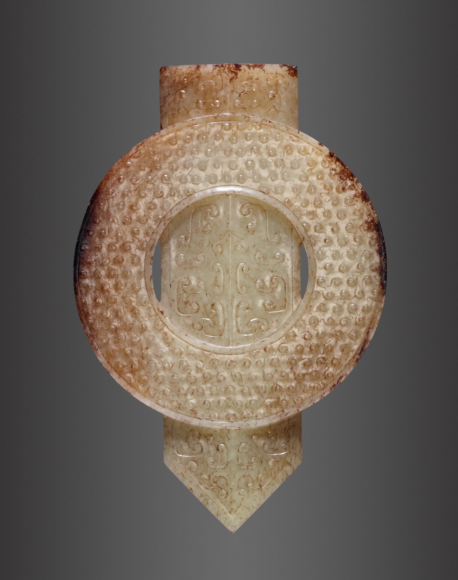 AN ARCHAISTIC PALE YELLOW AND RUSSET JADE DISC AND BLADE, GUIBI, QING