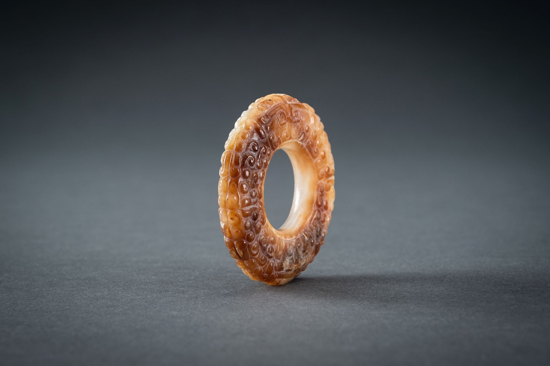 A WHITE AND RUSSET JADE 'CURLS AND TAOTIE MASKS' RING, HUAN, QING - Image 8 of 19