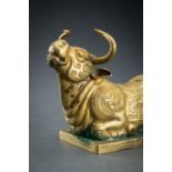 AN ARCHAISTIC FIRE-GILT COPPER REPOUSSÃ‰ FIGURE OF A RECUMBENT WATER BUFFALO