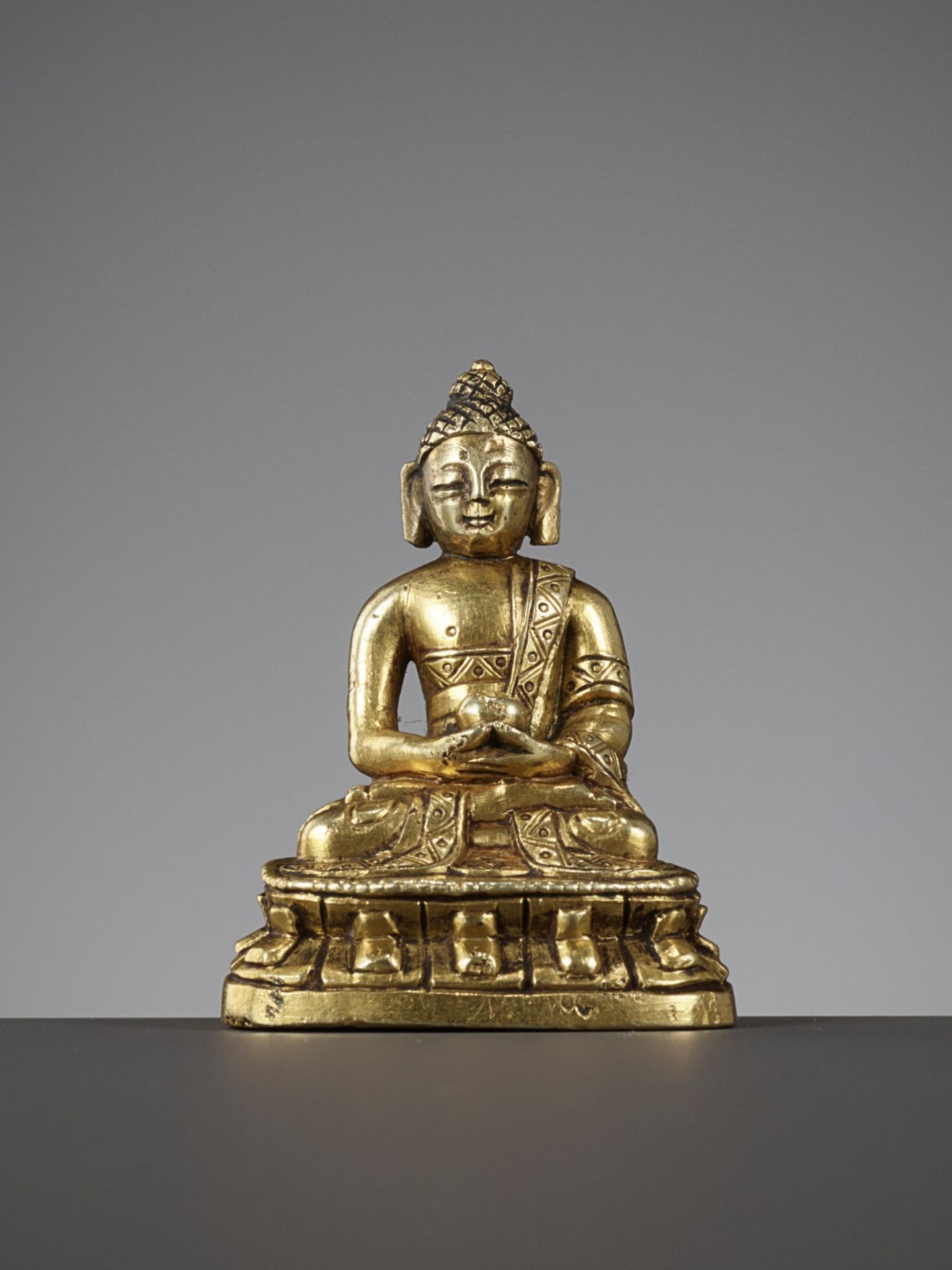 A VERY FINE GILT-BRONZE MINIATURE FIGURE OF BHAISAJYAGURU, QIANLONG PERIOD