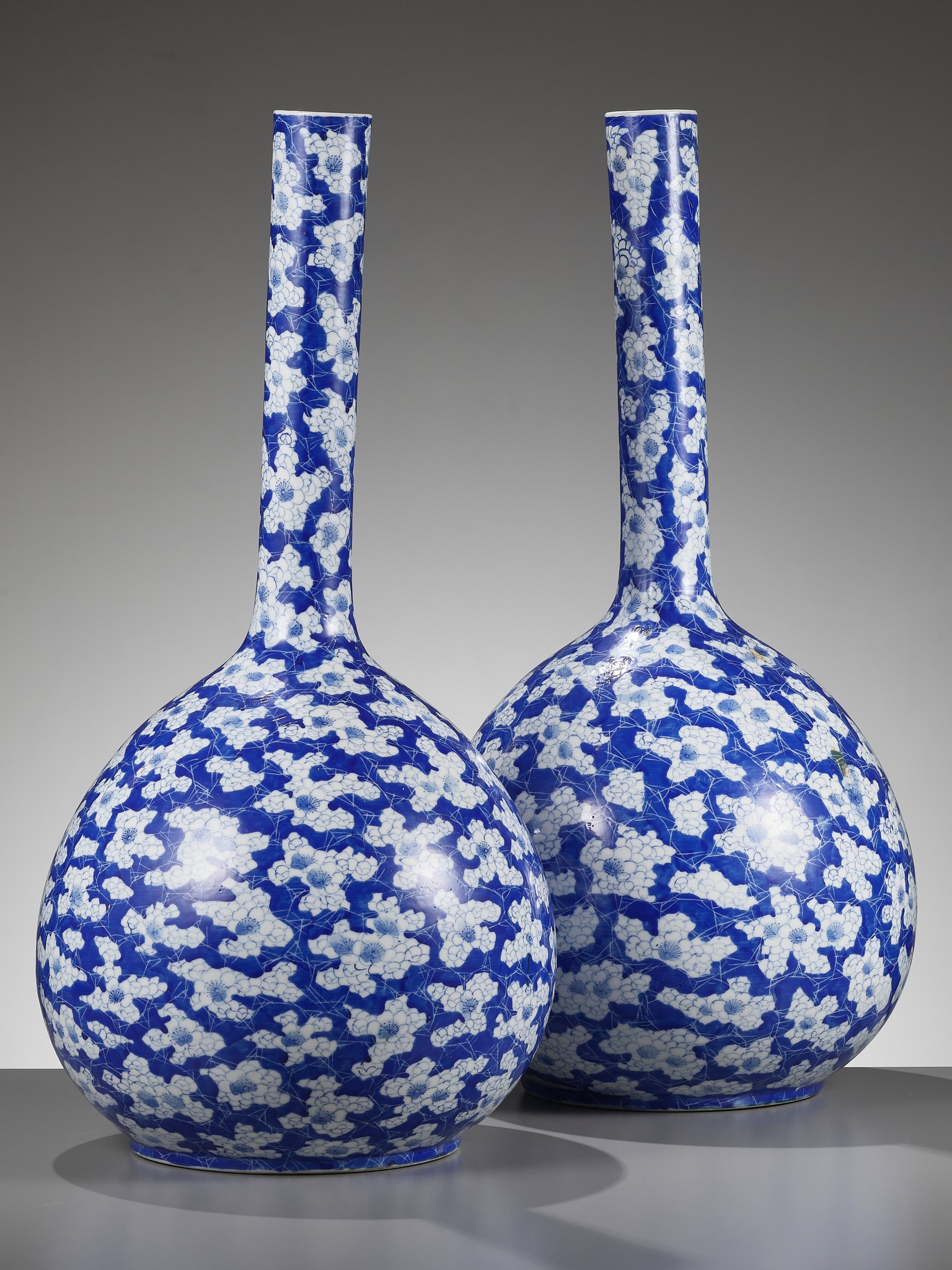 A PAIR OF BLUE AND WHITE 'ICE CRACK AND PRUNUS' BOTTLE VASES, 19TH CENTURY