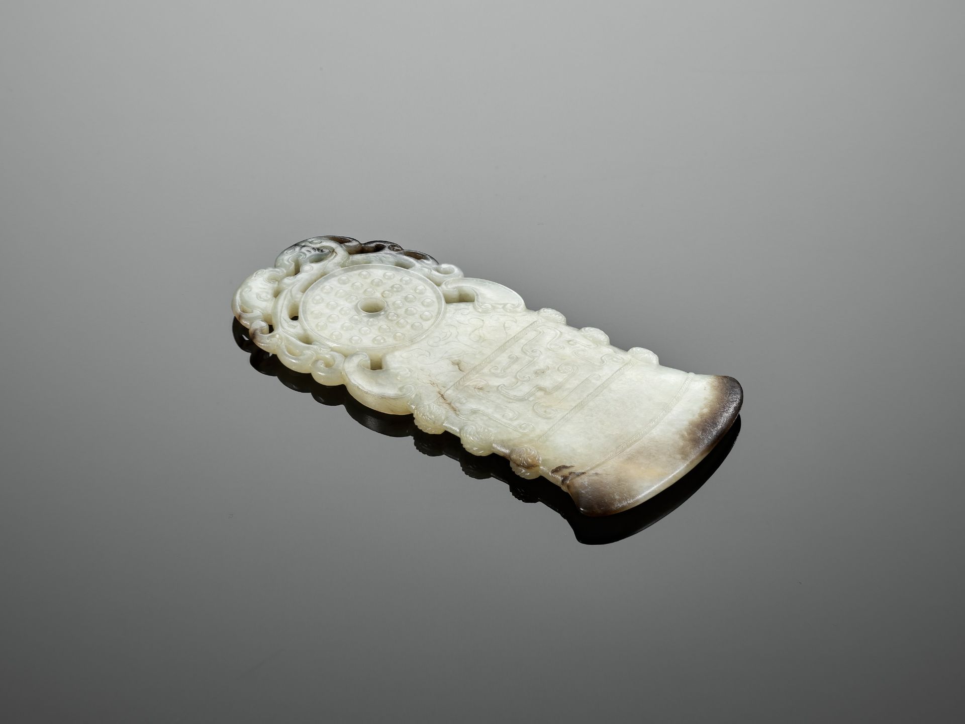 A BLACK AND WHITE JADE 'ARCHAISTIC' AXE-FORM OPENWORK PENDANT, 18TH CENTURY - Image 6 of 9