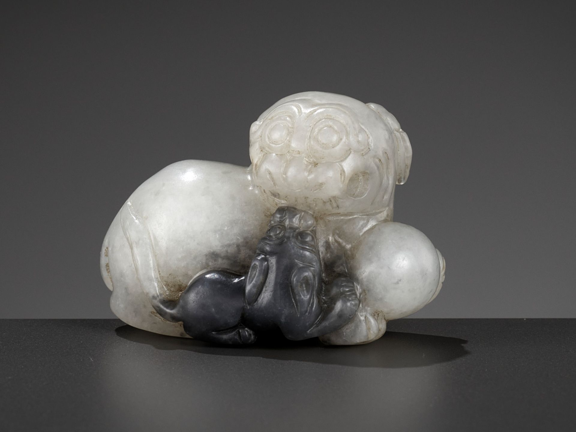 A WHITE AND GRAY JADE GROUP OF A LION AND CUB, LATE MING TO EARLY QING DYNASTY