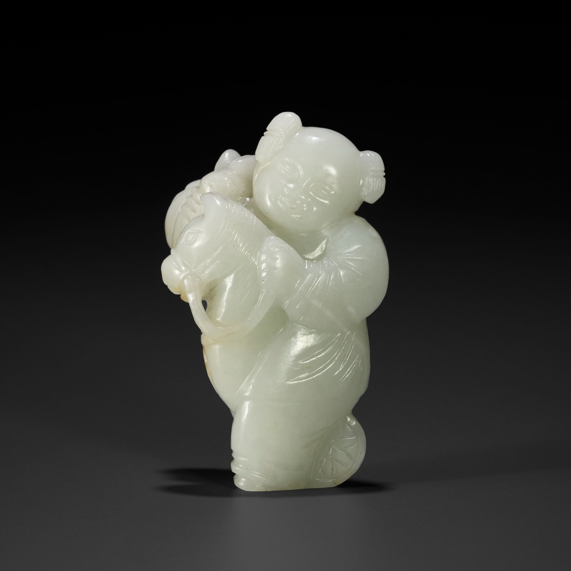 A PALE CELADON FIGURE OF A BOY WITH A HOBBY HORSE, 18TH CENTURY