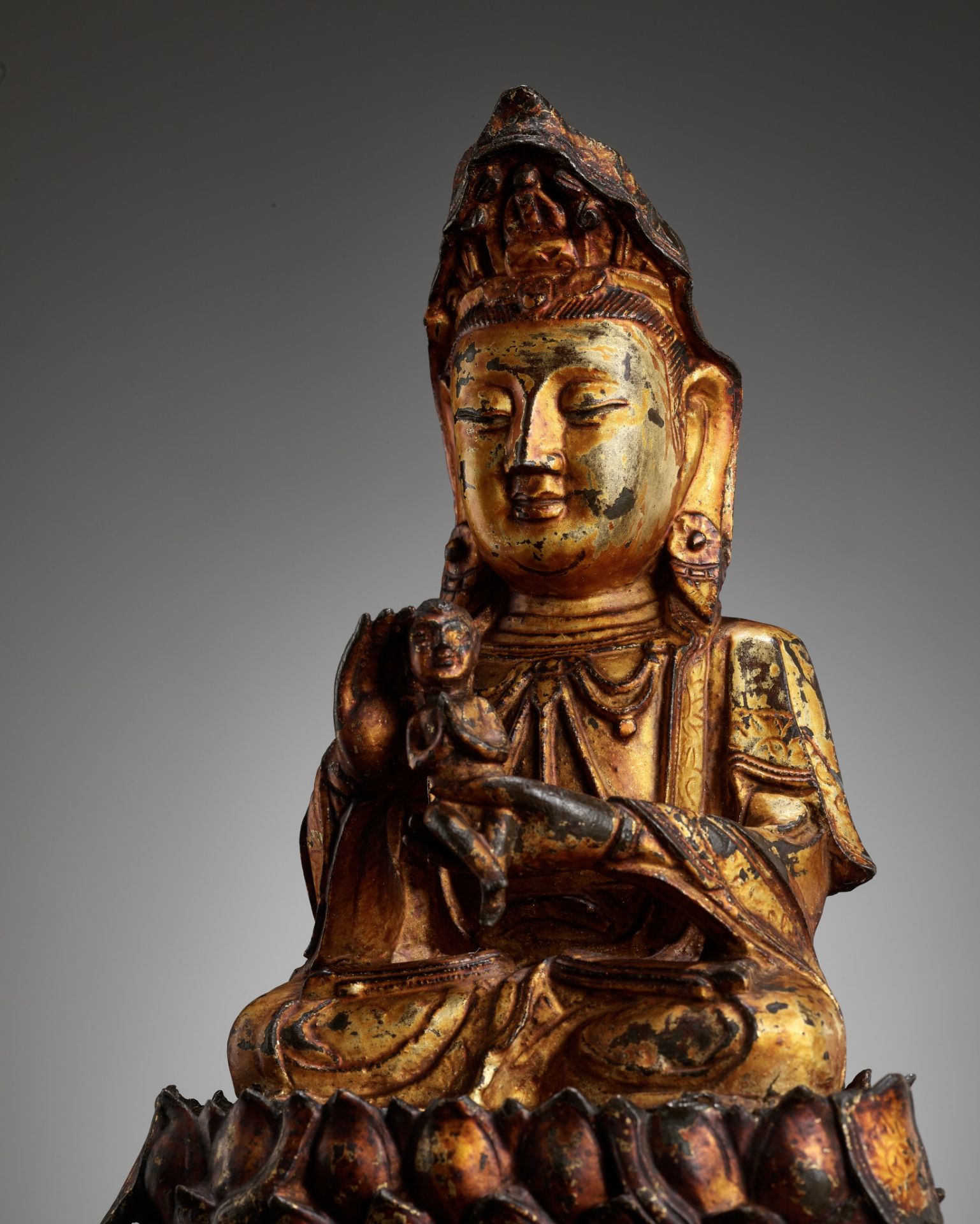 A GILT-LACQUERED BRONZE FIGURE OF SONGZI GUANYIN, MING DYNASTY