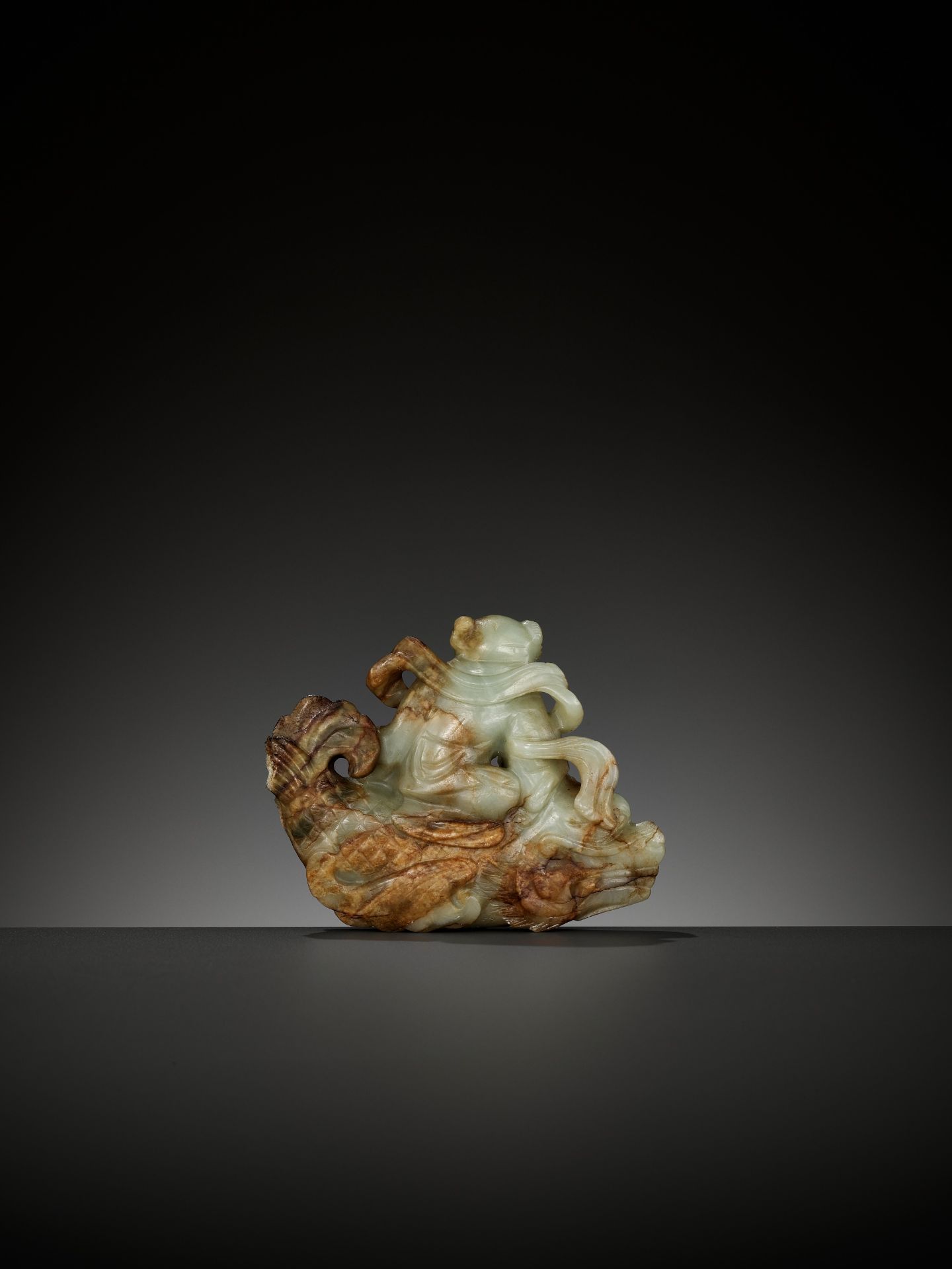 A CELADON AND RUSSET JADE FIGURE OF A BOY RIDING A DRAGON-CARP, 17TH-18TH CENTURY - Image 2 of 13