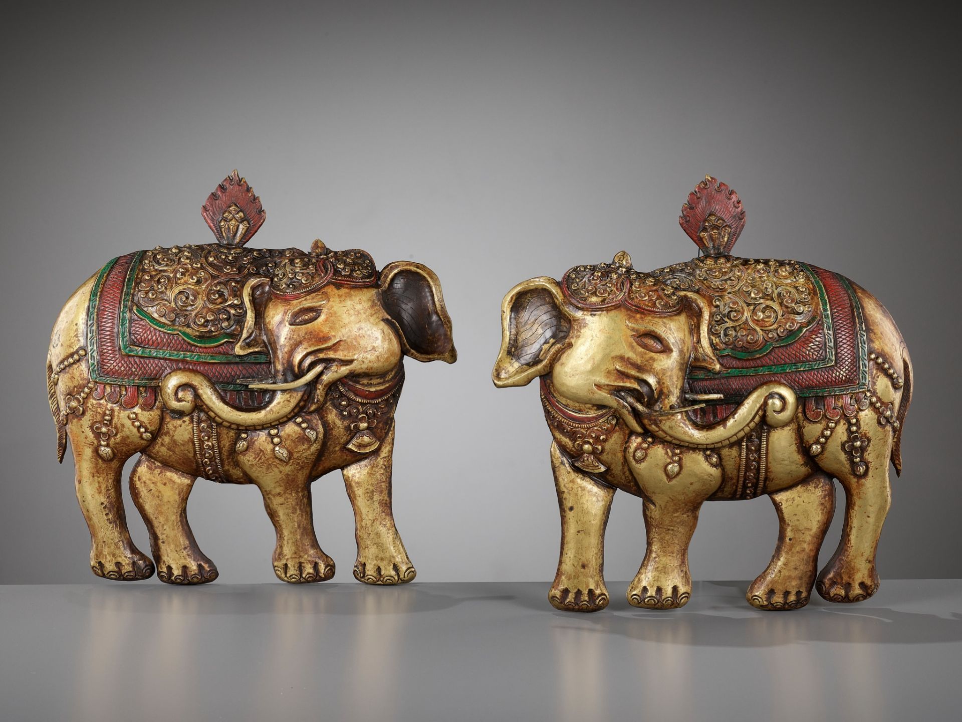 A PAIR OF GILT AND POLYCHROME-DECORATED COPPER REPOUSSE PLAQUES, HASTIRATNA, 17TH-18TH CENTURY