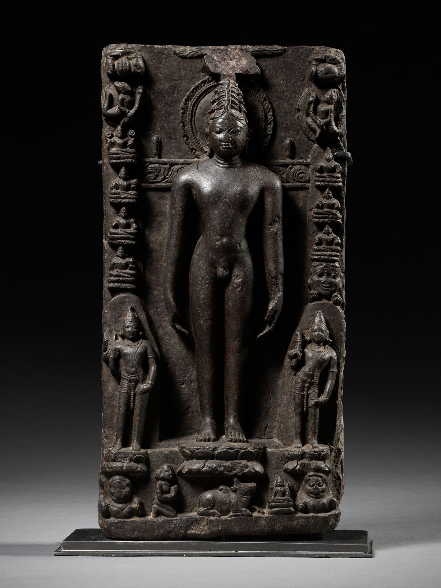 A BLACK STONE STELE DEPICTING RISHABHANATHA, THE FIRST TIRTHANKARA