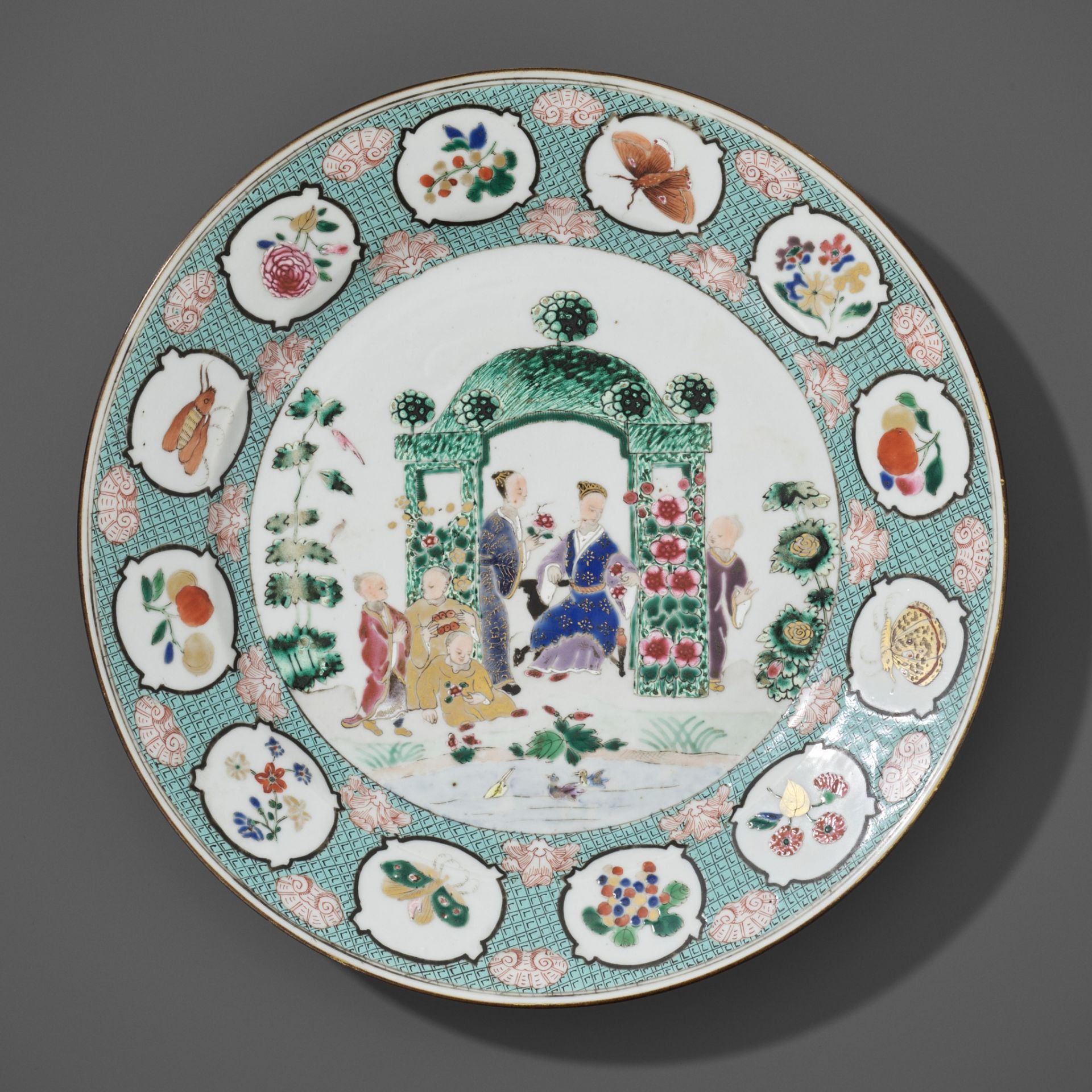 A FAMILLE ROSE 'IN THE ARBOR' DISH BY CORNELIUS PRONK, CHINA, 1735-1740