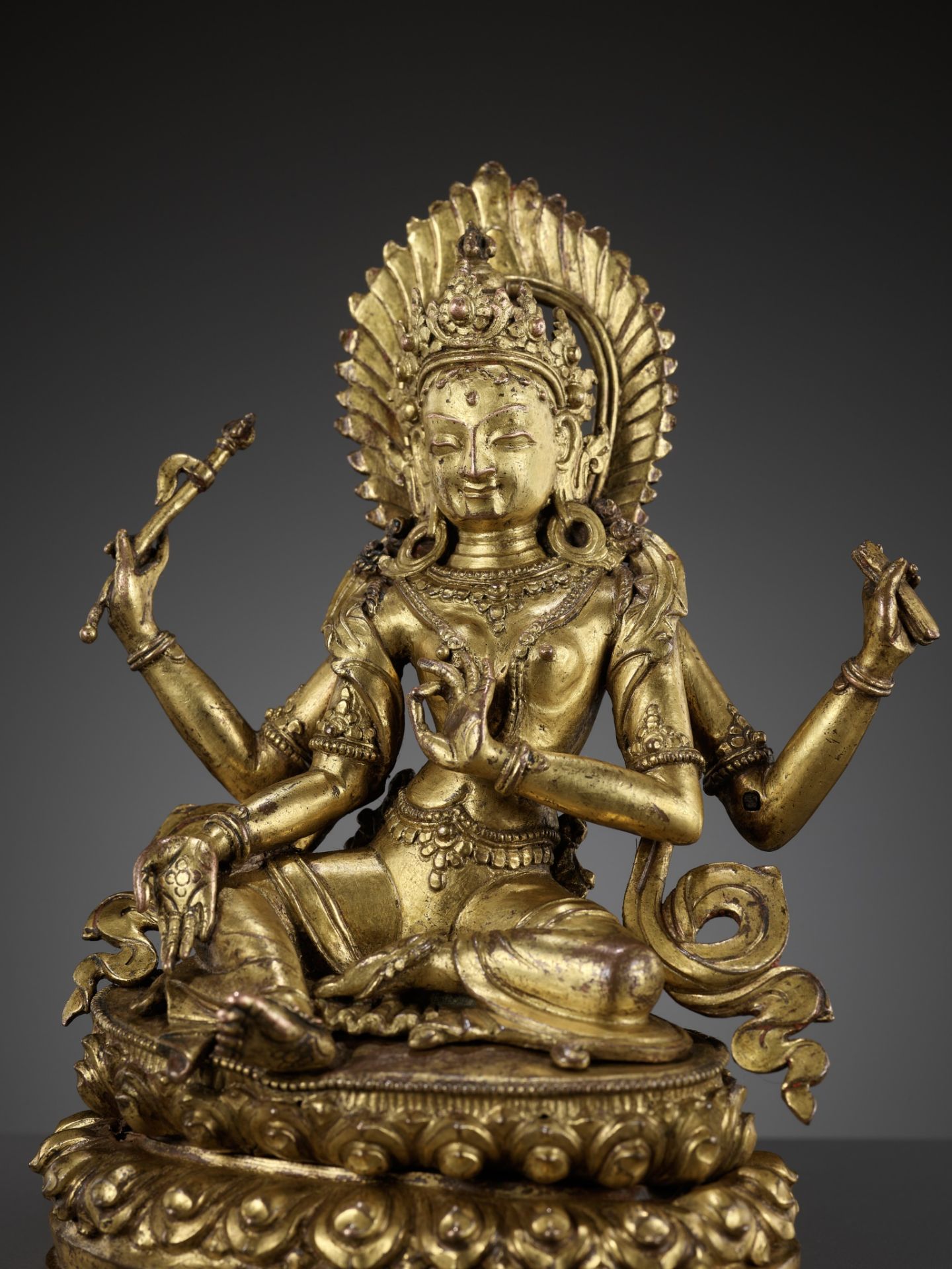 A CAST AND REPOUSSE GILT COPPER ALLOY FIGURE OF TARA, NEPAL, 18TH-19TH CENTURY