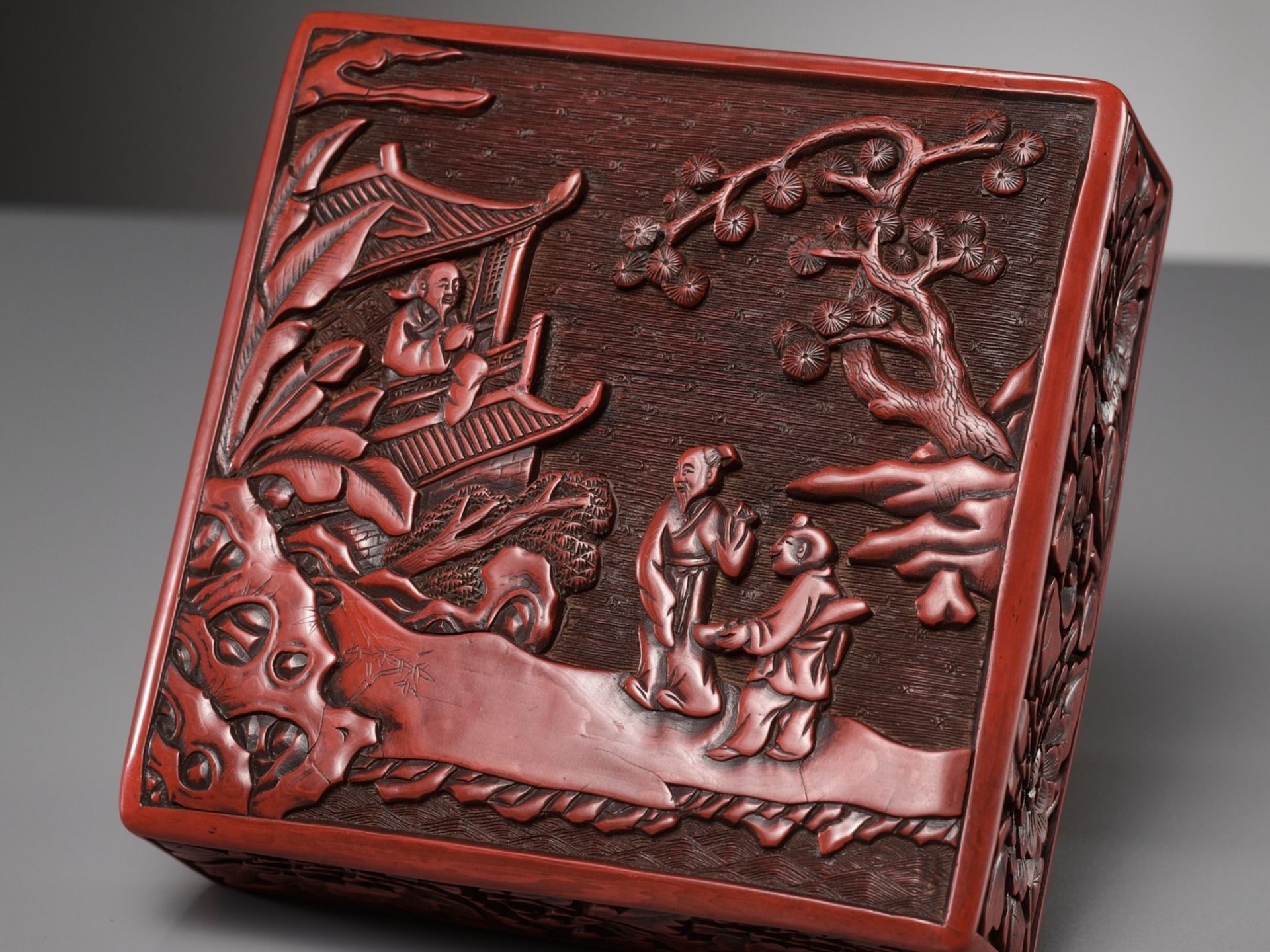 A CINNABAR LACQUER THREE-TIERED BOX AND COVER, LATE YUAN TO MID-MING DYNASTY