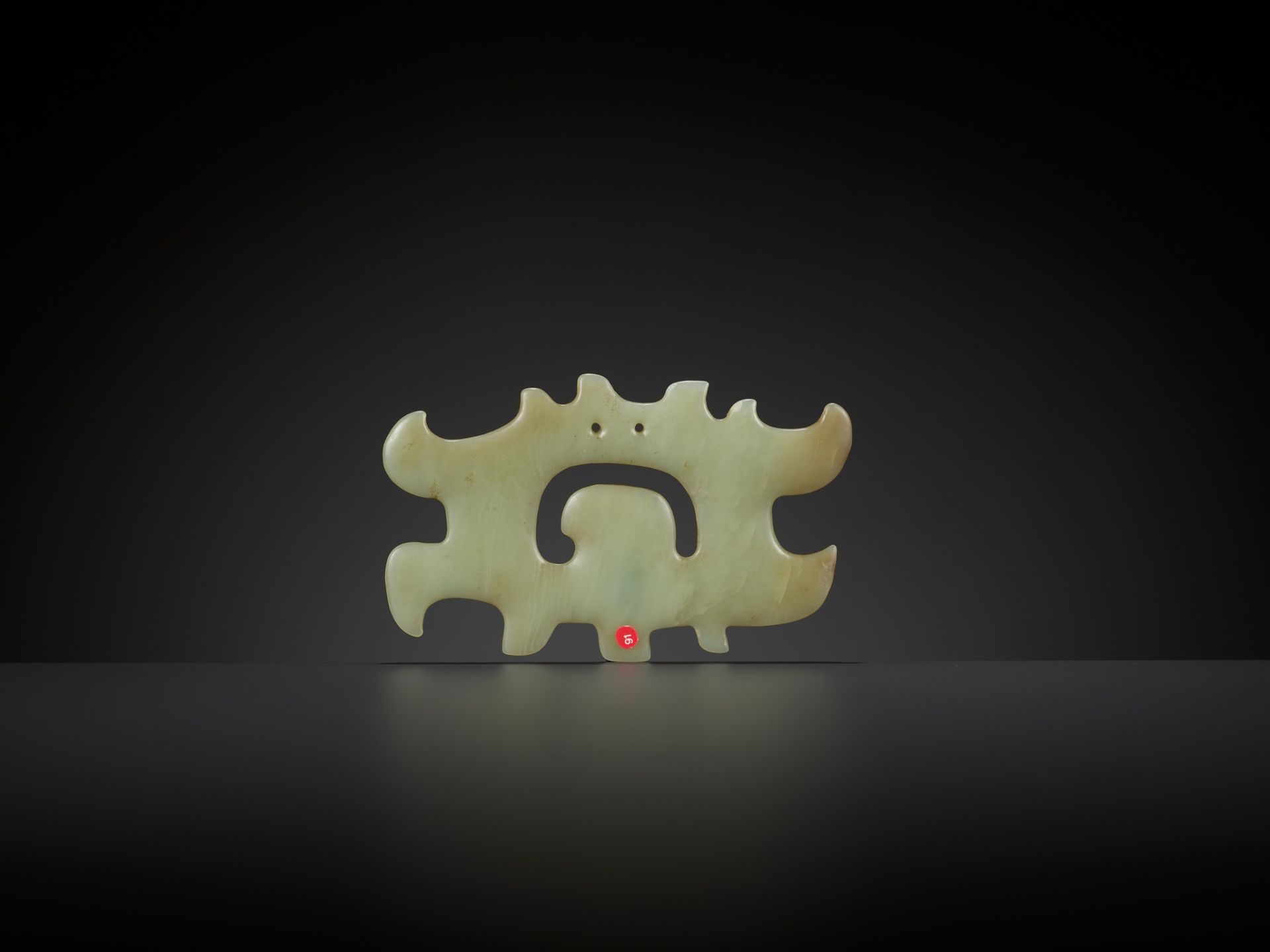 A PALE GREEN JADE 'CLOUD-SCROLL' PENDANT, HONGSHAN CULTURE - Image 2 of 9