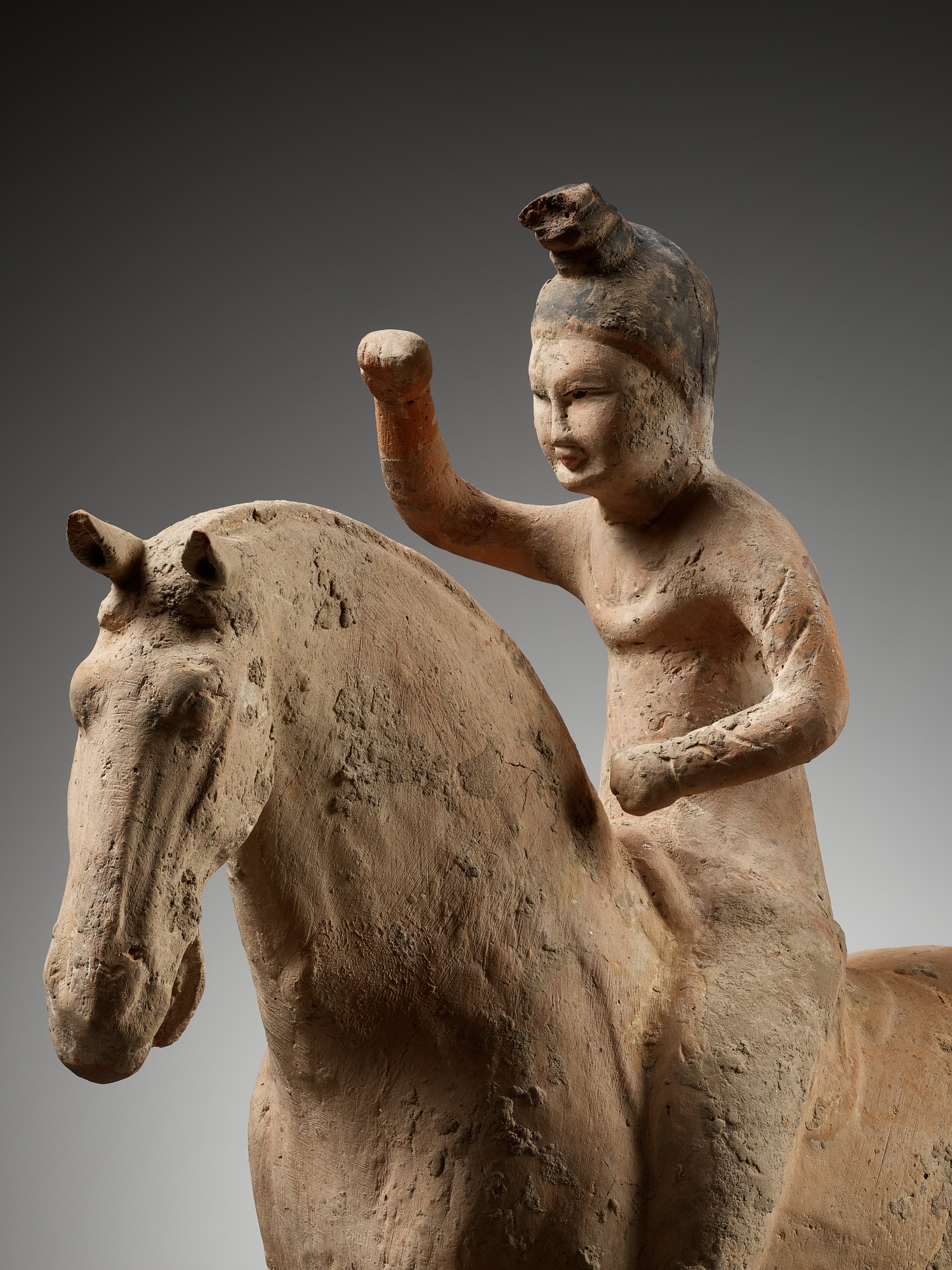A PAINTED POTTERY FIGURE OF A POLO PLAYER, SUI TO TANG DYNASTY