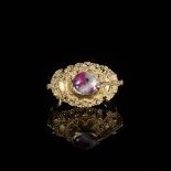 A CORUNDUM-SET GOLD 'FLOWERS AND BIRD' PRIEST'S RING