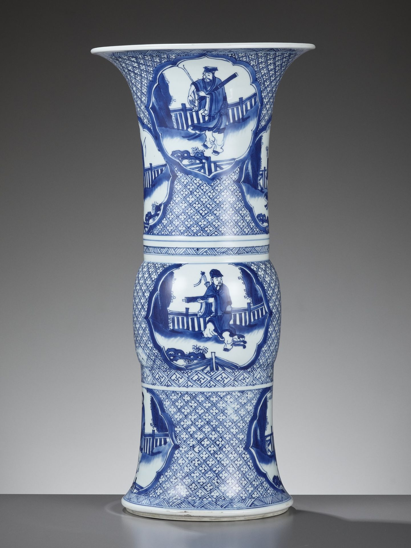 A RARE BLUE AND WHITE 'EIGHT IMMORTALS' BEAKER VASE, GU, KANGXI PERIOD