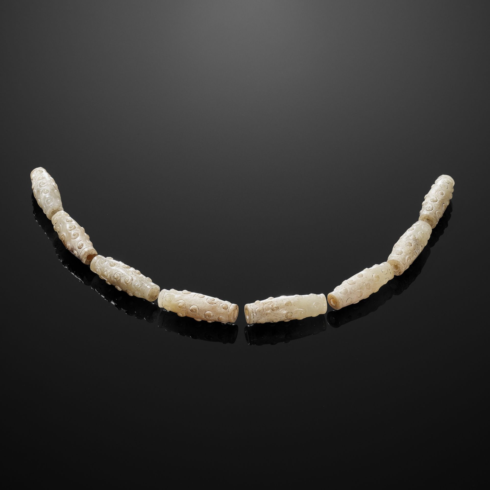 EIGHT BI-CONICAL WHITE JADE BEADS, EASTERN ZHOU