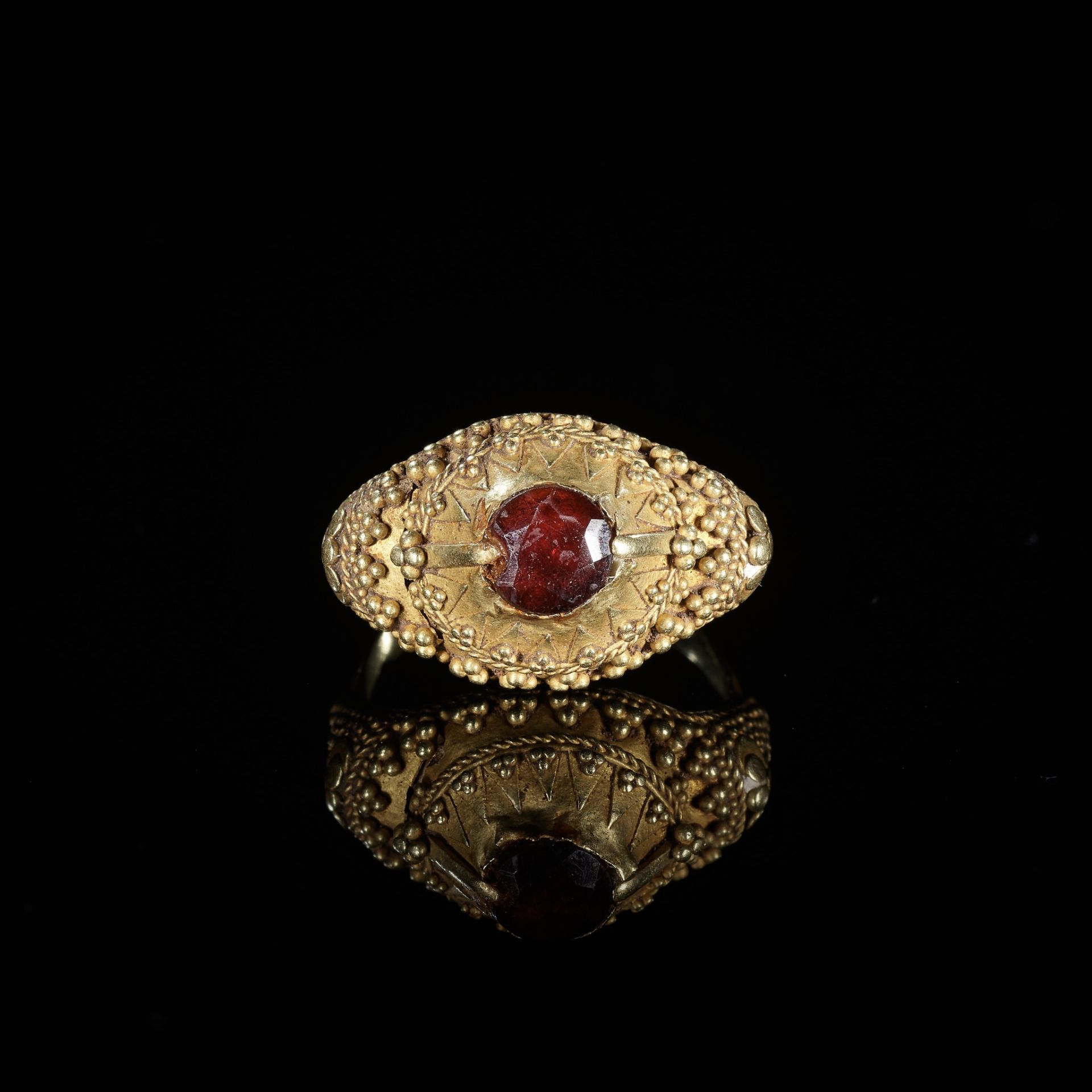 A GARNET-SET GOLD 'FLORAL' PRIEST'S RING