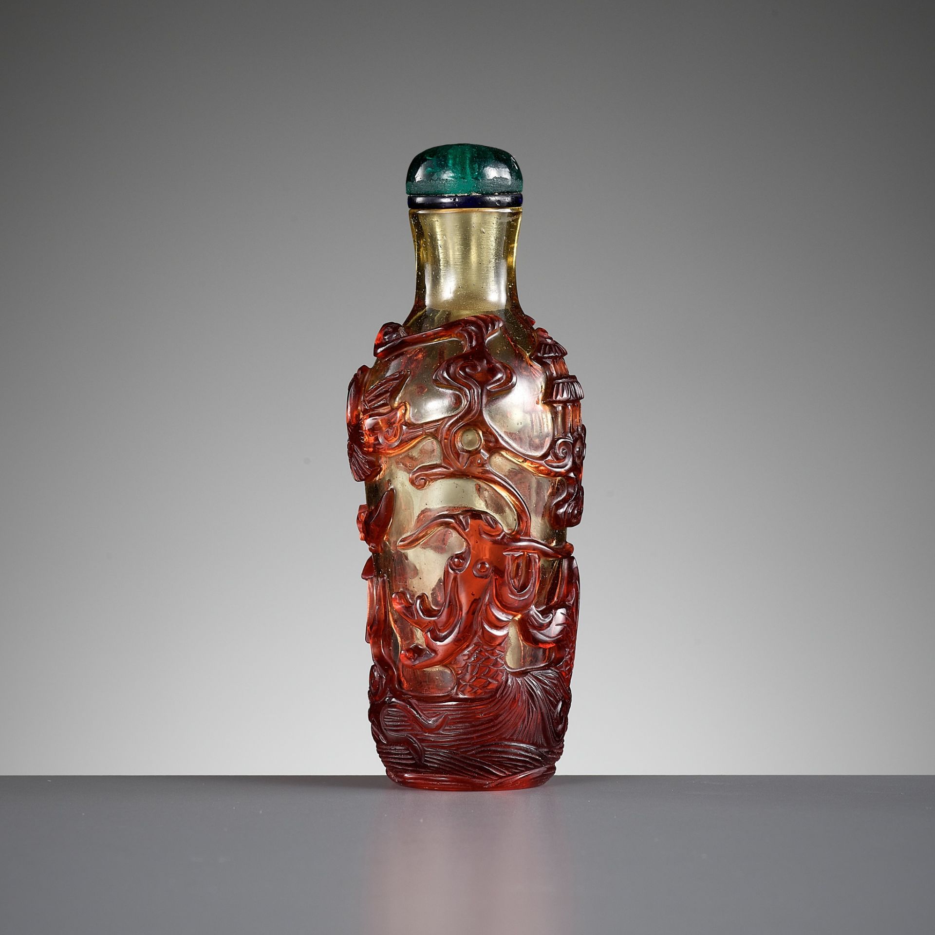 A RUBY-RED OVERLAY GLASS 'DRAGON CARP' SNUFF BOTTLE, QING DYNASTY