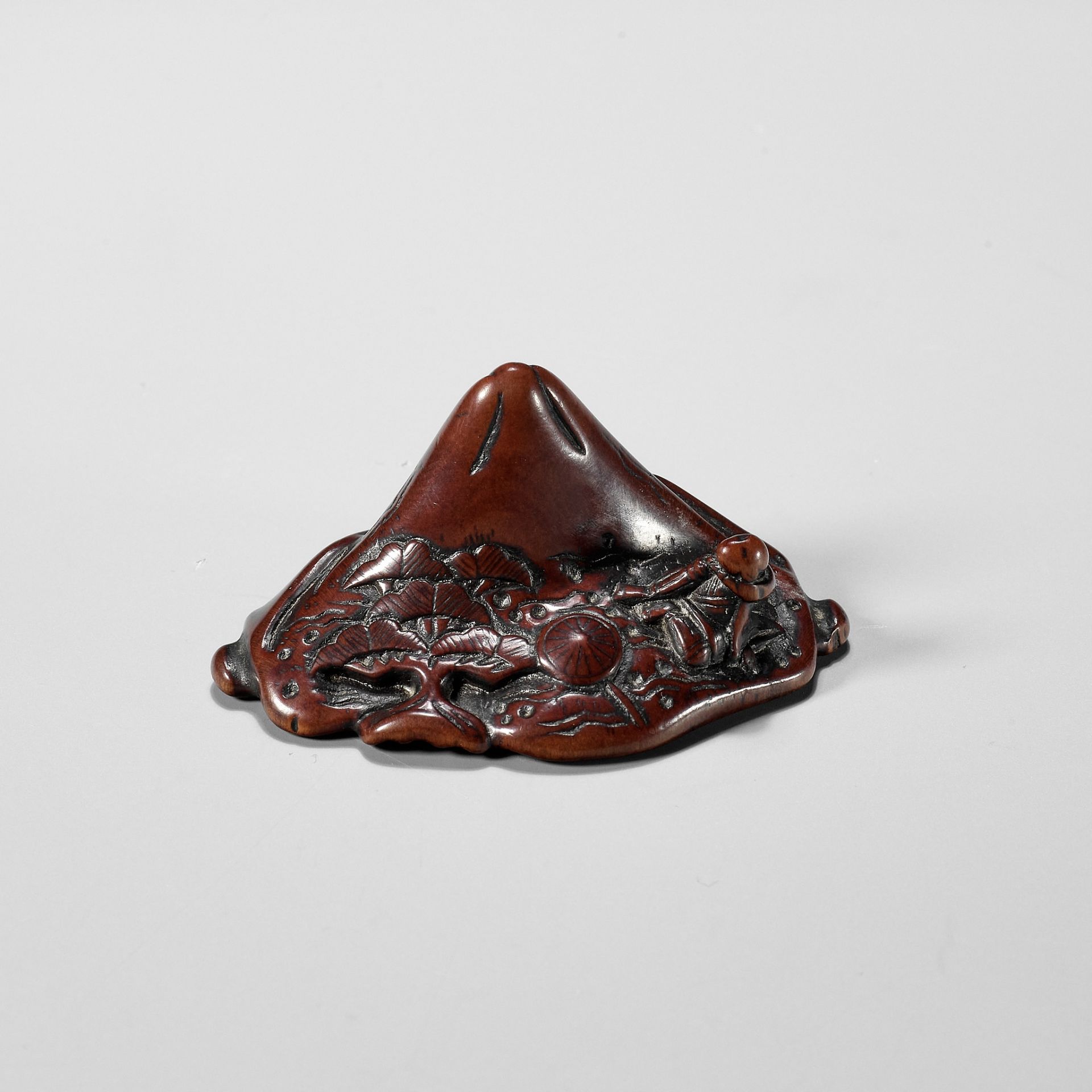 A WOOD NETSUKE OF SAIGYO HOSHI ADMIRING MOUNT FUJI