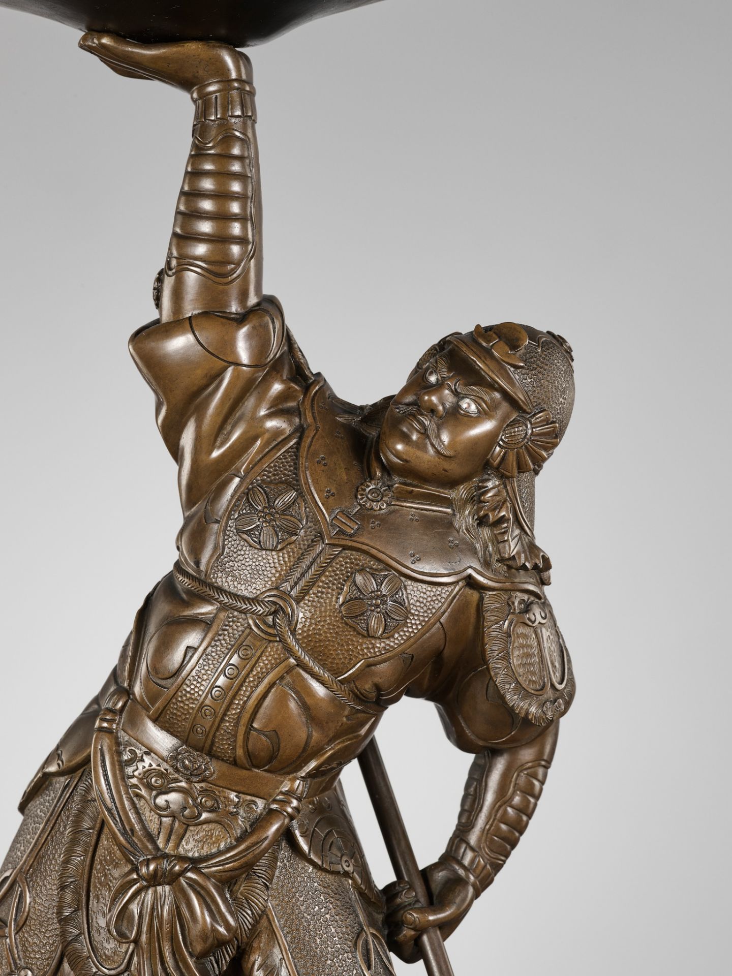 A BRONZE FIGURE OF A SAMURAI LIFTING A GONG