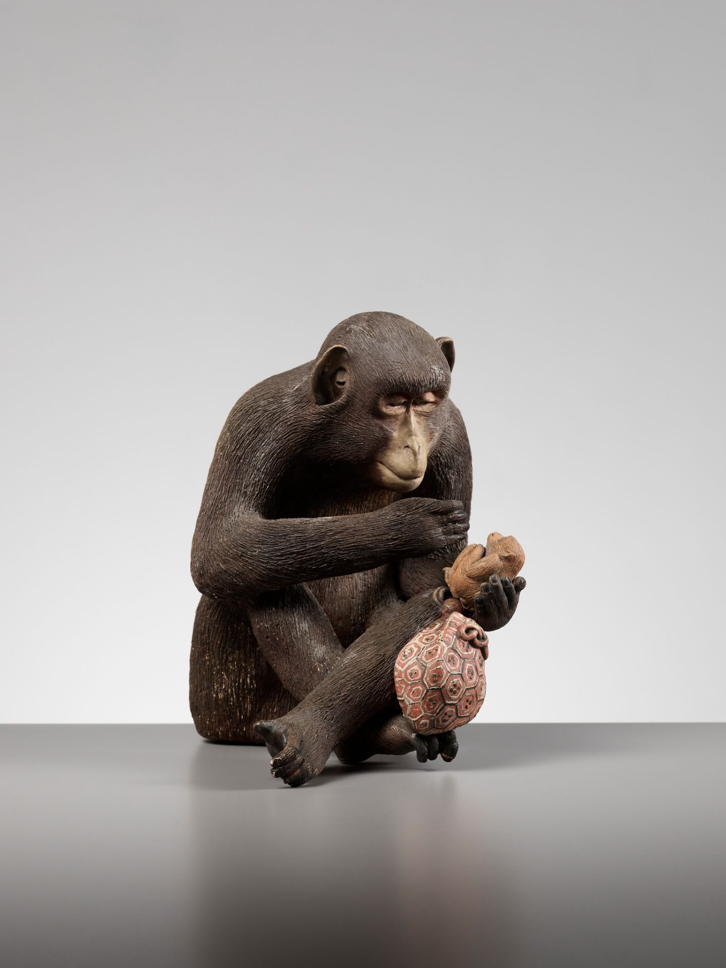 A RARE AND LARGE PAINTED POTTERY OKIMONO OF A MONKEY EXAMINING A MONKEY NETSUKE - Image 4 of 11