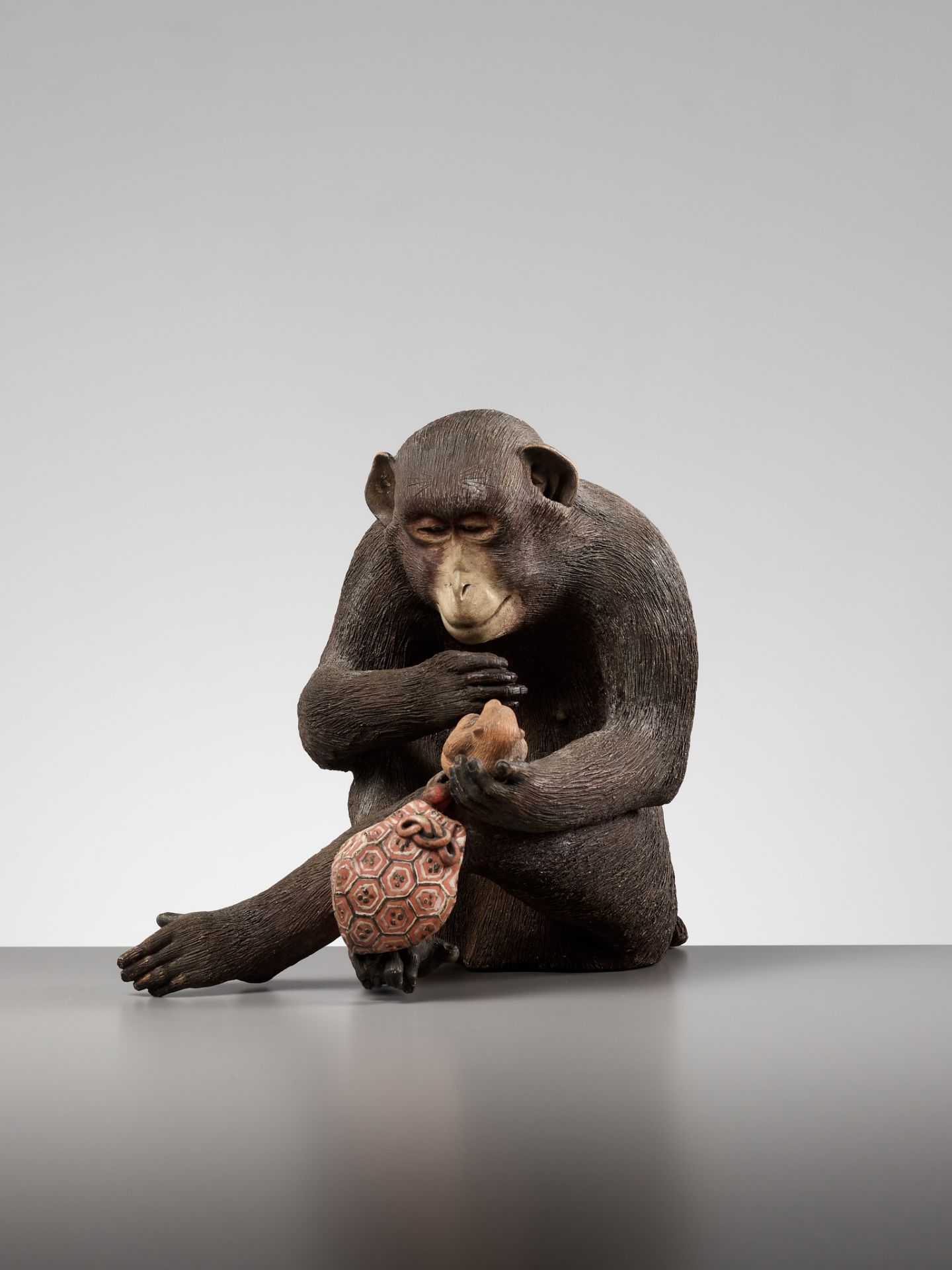 A RARE AND LARGE PAINTED POTTERY OKIMONO OF A MONKEY EXAMINING A MONKEY NETSUKE - Image 6 of 11