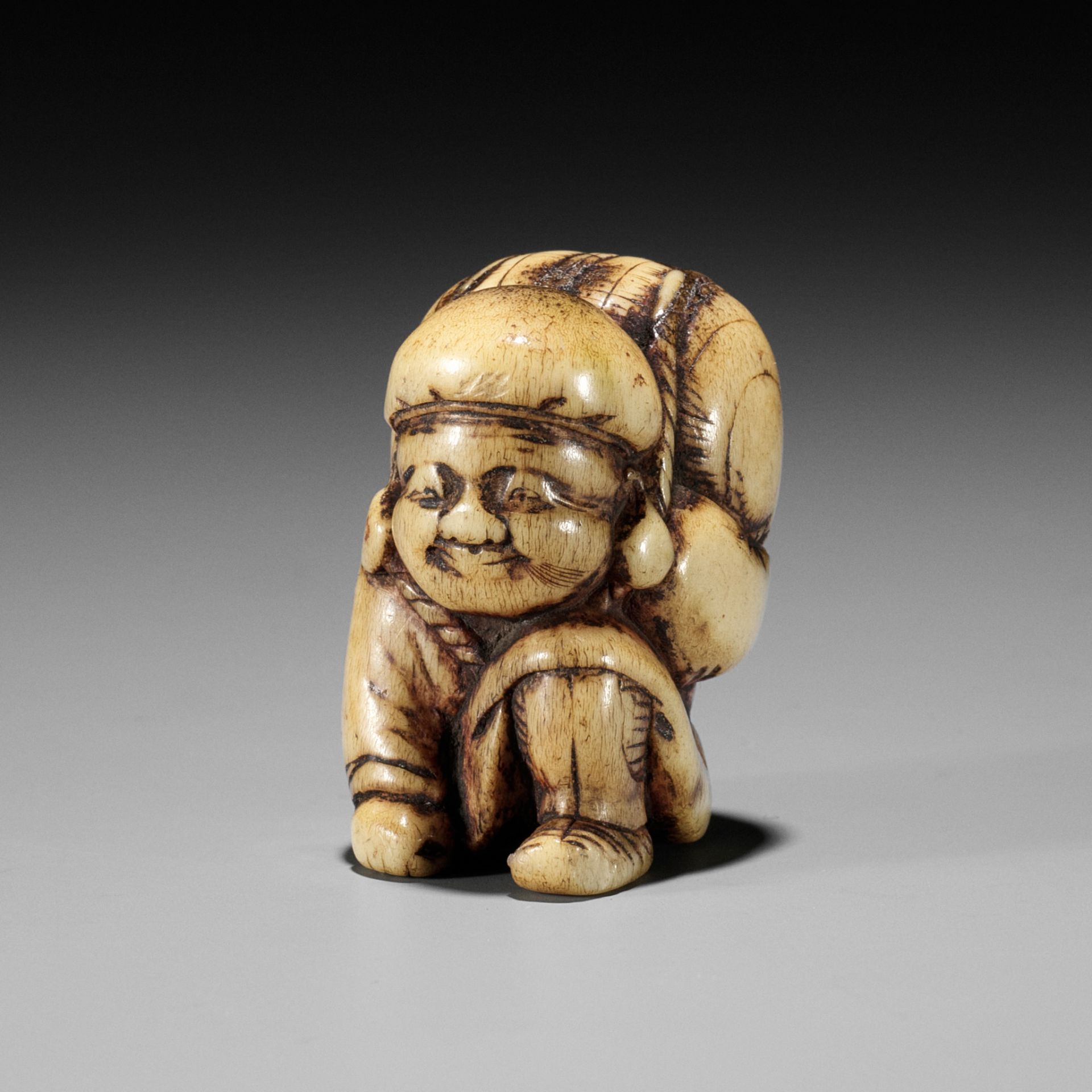 A GOOD STAG ANTLER NETSUKE OF DAIKOKU