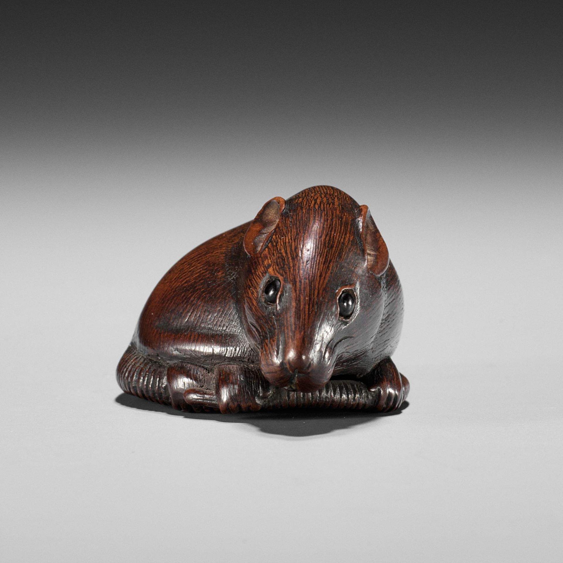 TOMOKAZU: A FINE WOOD NETSUKE OF A RAT