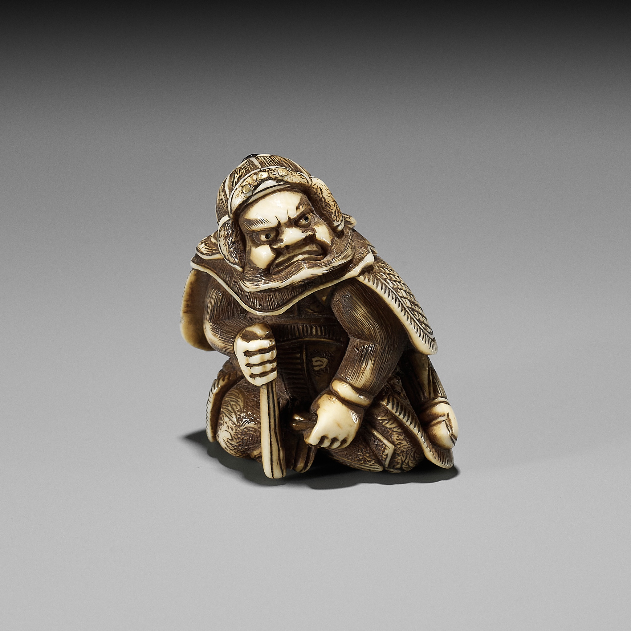 A RARE IVORY NETSUKE OF A WARRIOR