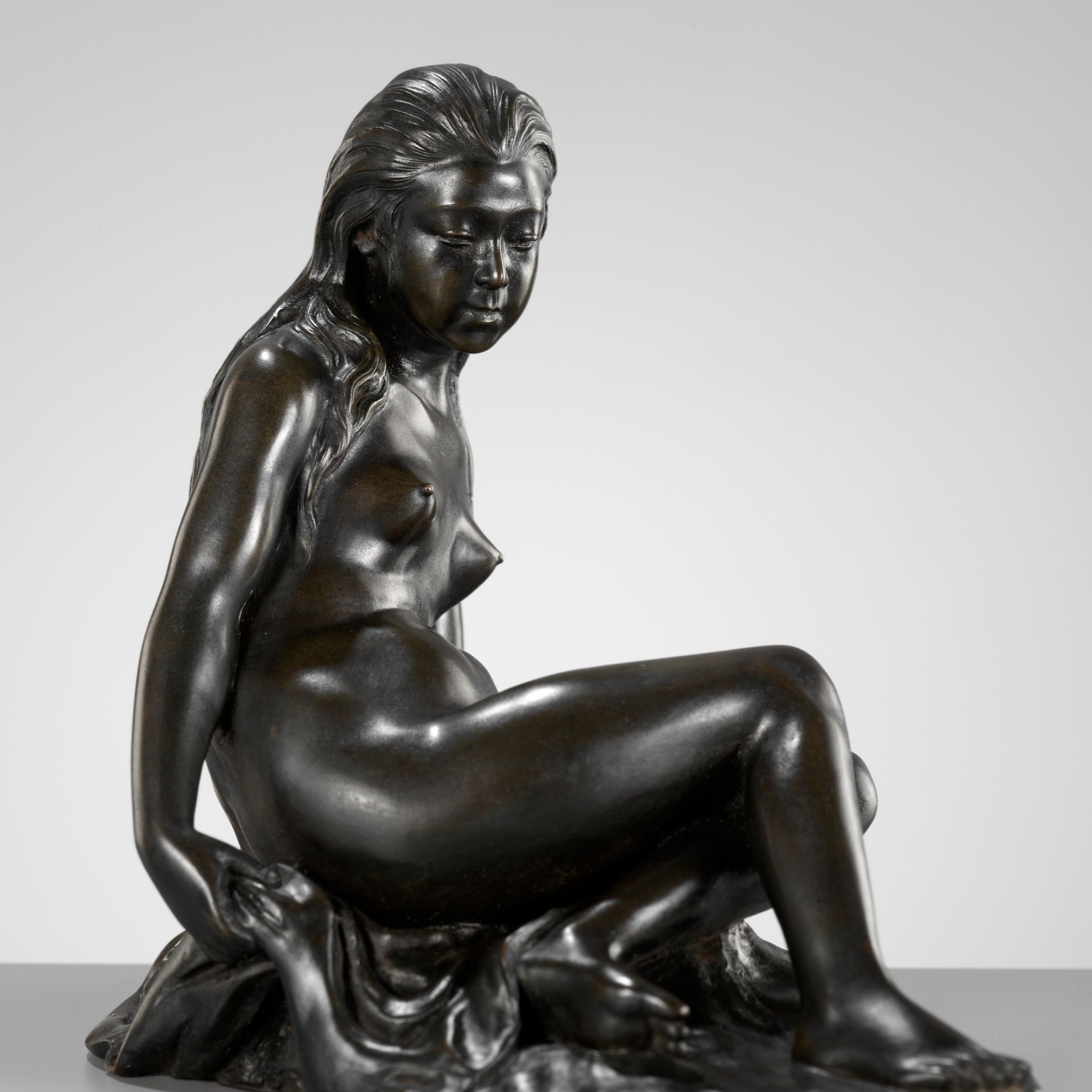 ATSUYOSHI FOR THE MARUKI COMPANY: A MASTERFUL BRONZE 'PORTRAIT' OKIMONO OF A BATHING NUDE