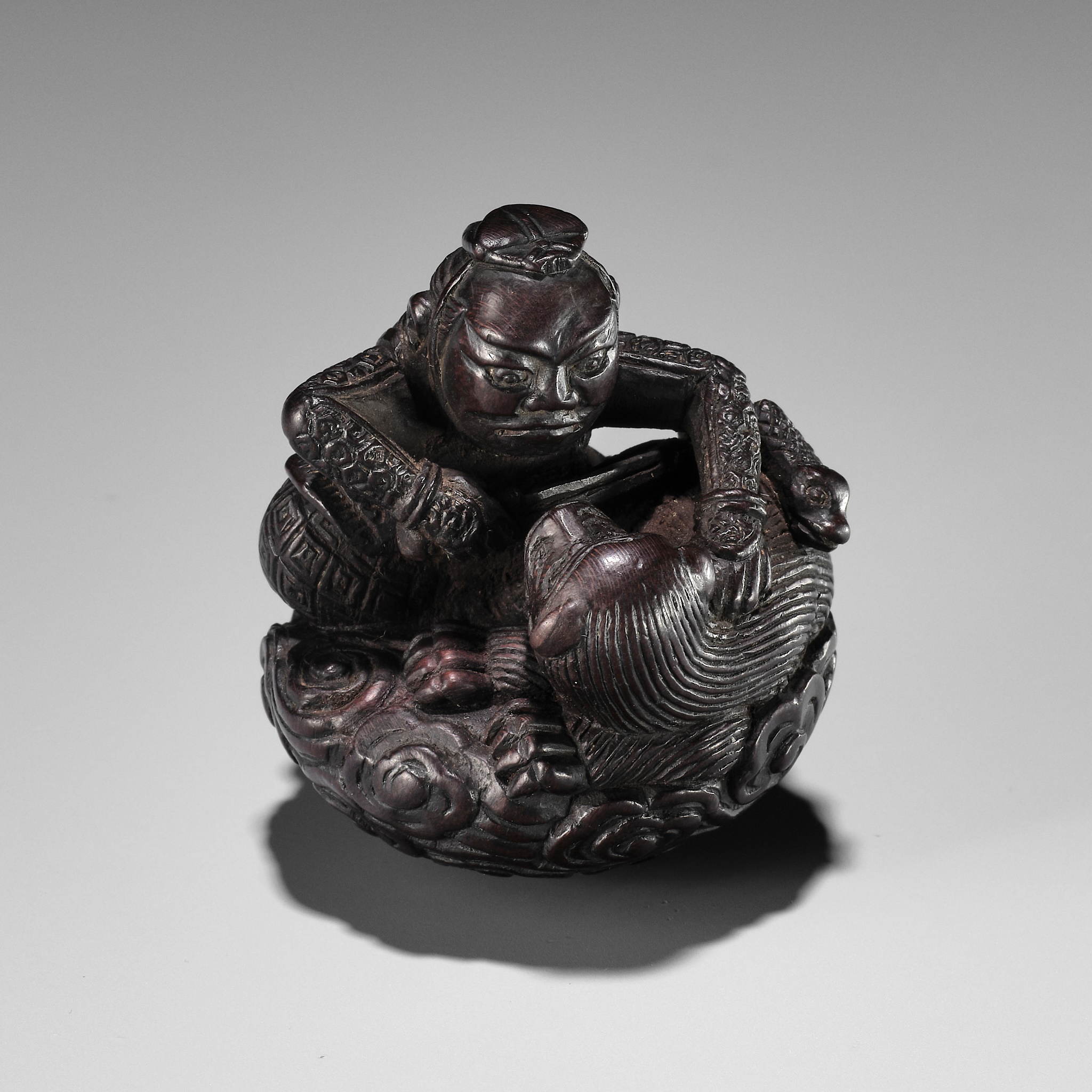 A POWERFUL WOOD NETSUKE OF INO HAYATA SLAYING THE NUE