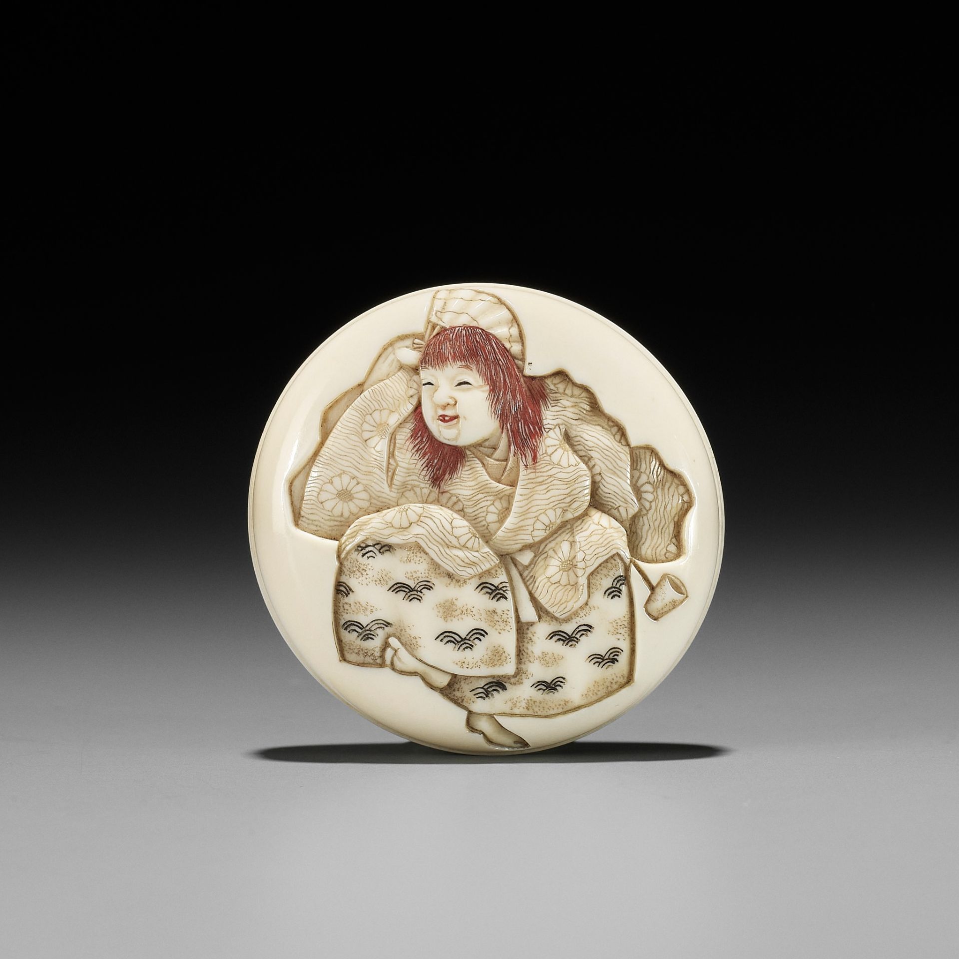 IKKOSAI: AN IVORY MANJU NETSUKE OF A DRUNKEN SHOJO