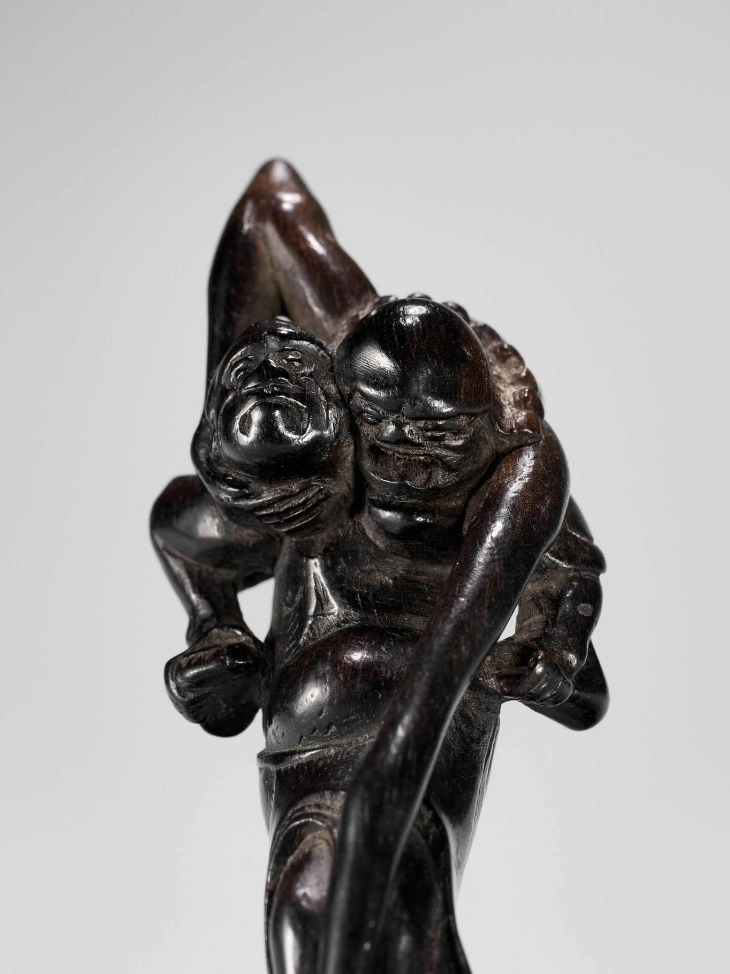 A TALL EBONY WOOD NETSUKE OF ASHINAGA AND TENAGA