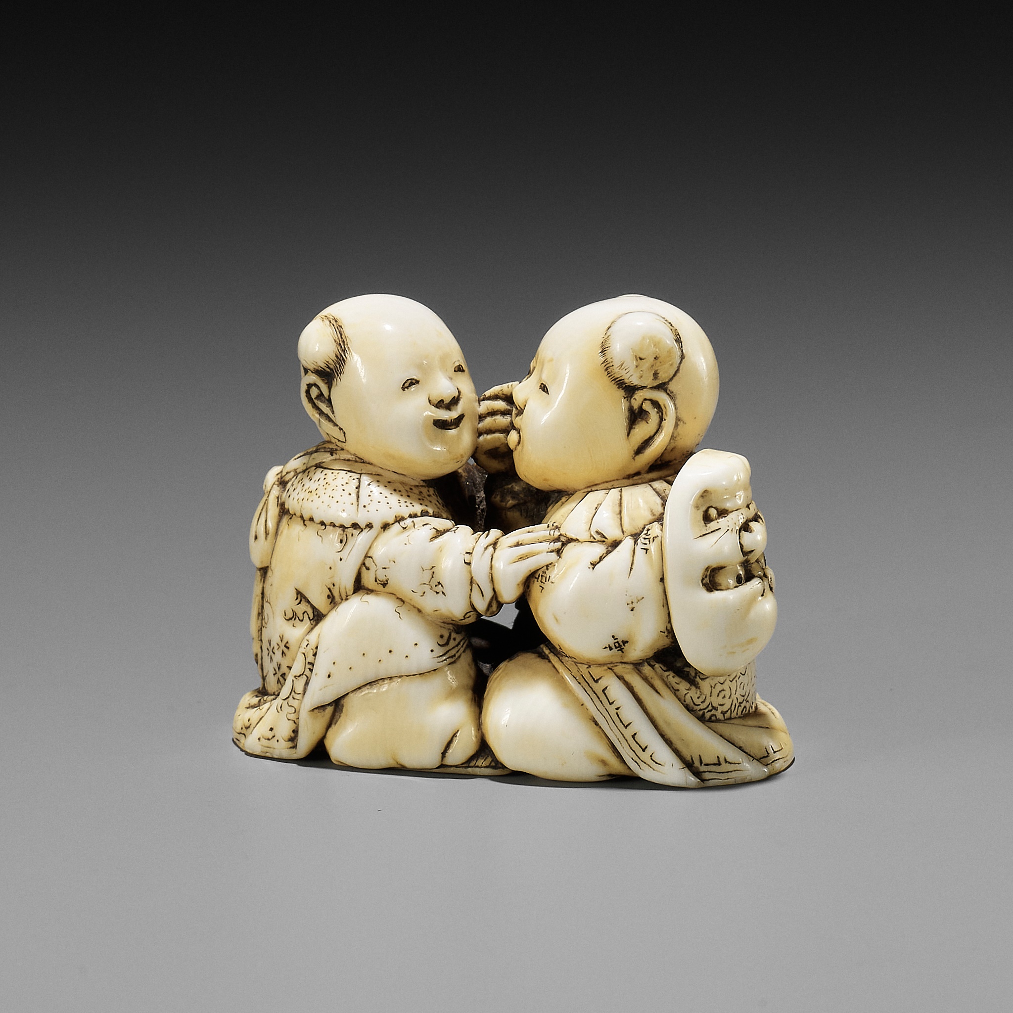 TADACHIKA: AN IVORY NETSUKE OF TWO PLAYING KARAKO