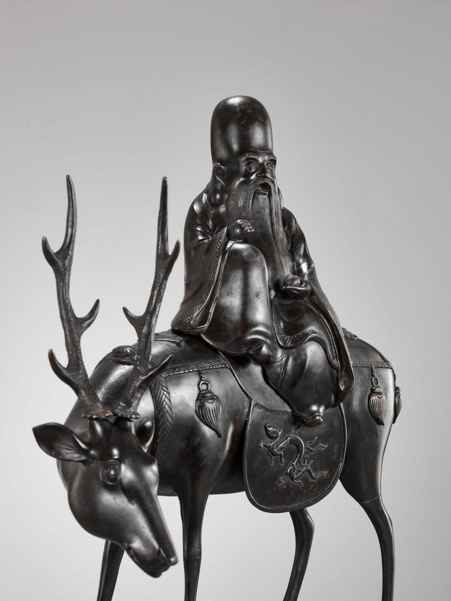 A MASSIVE BRONZE KORO (CENSER) OF JUROJIN SEATED ON A DEER