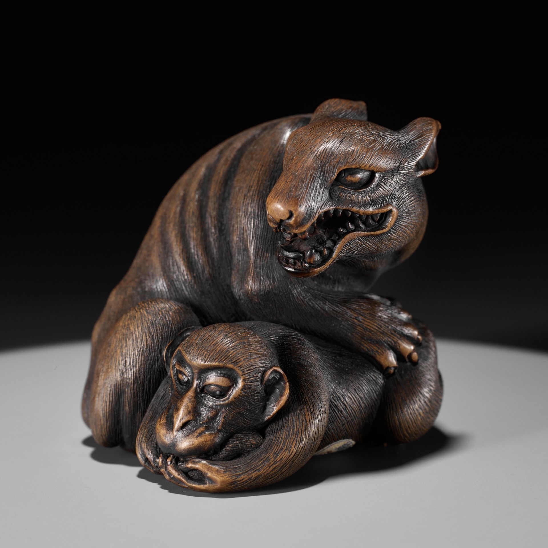 A LARGE AND FINE YAMADA SCHOOL WOOD OKIMONO NETSUKE OF A WOLF AND MONKEY