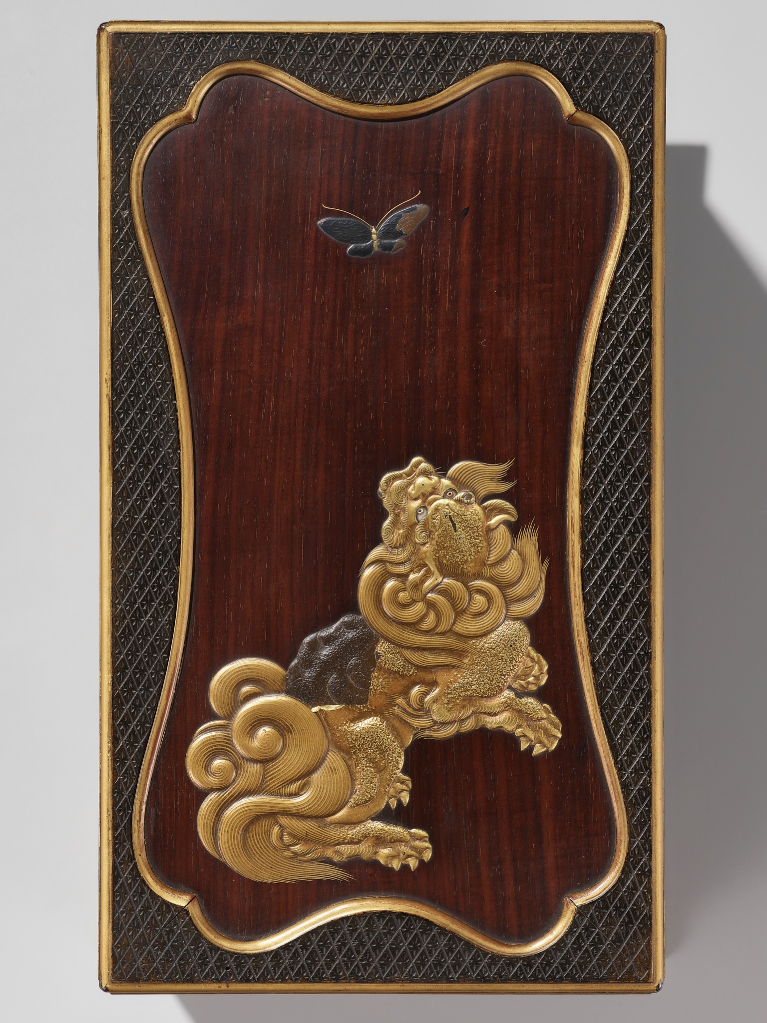 A RARE LACQUERED WOOD SUZURIBAKO (WRITING BOX) DEPICTING A SHISHI AND BUTTERFLY