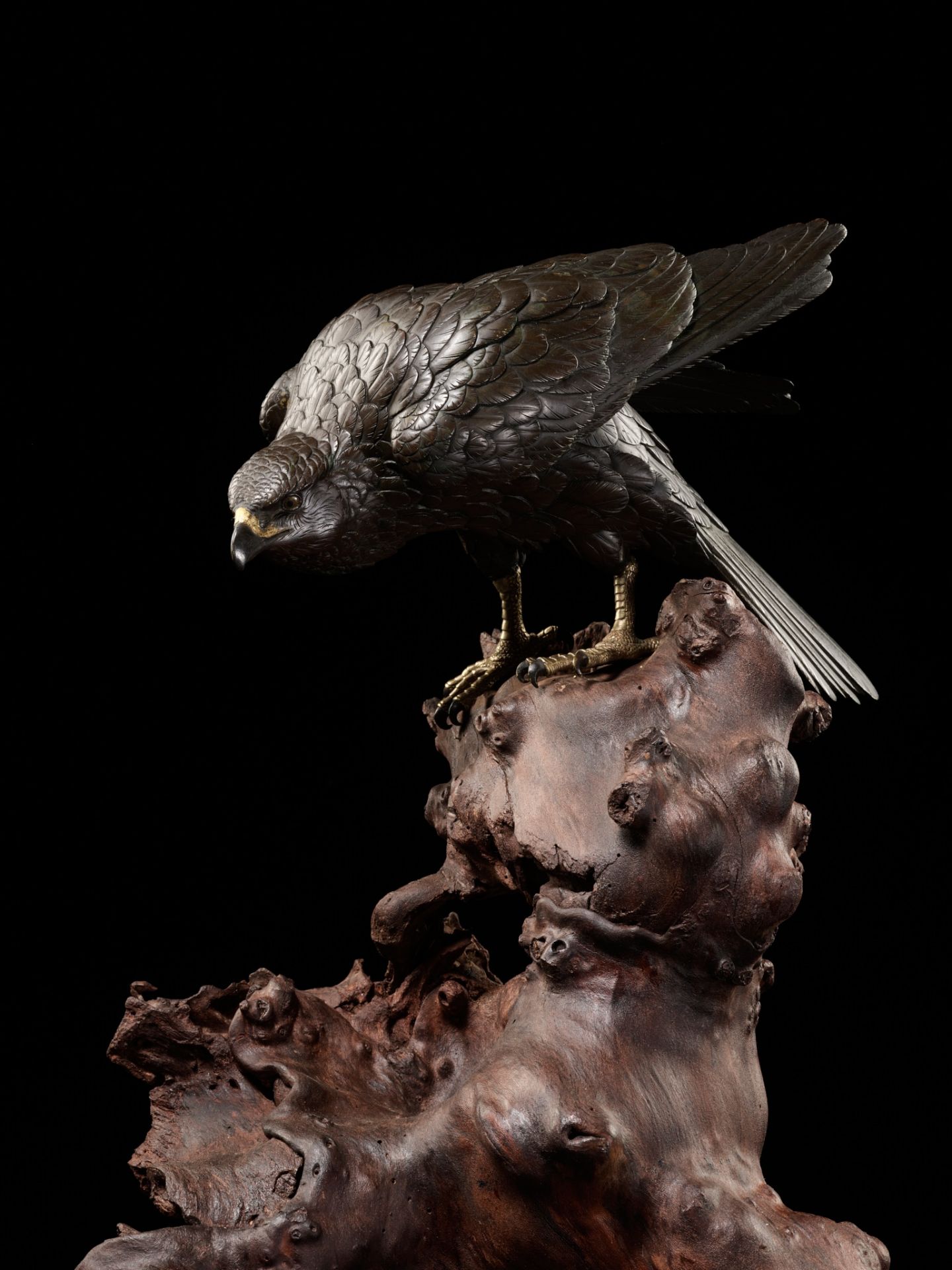 MASATSUNE: A SUPERB AND LARGE BRONZE OKIMONO OF A HAWK ON ROOTWOOD BASE