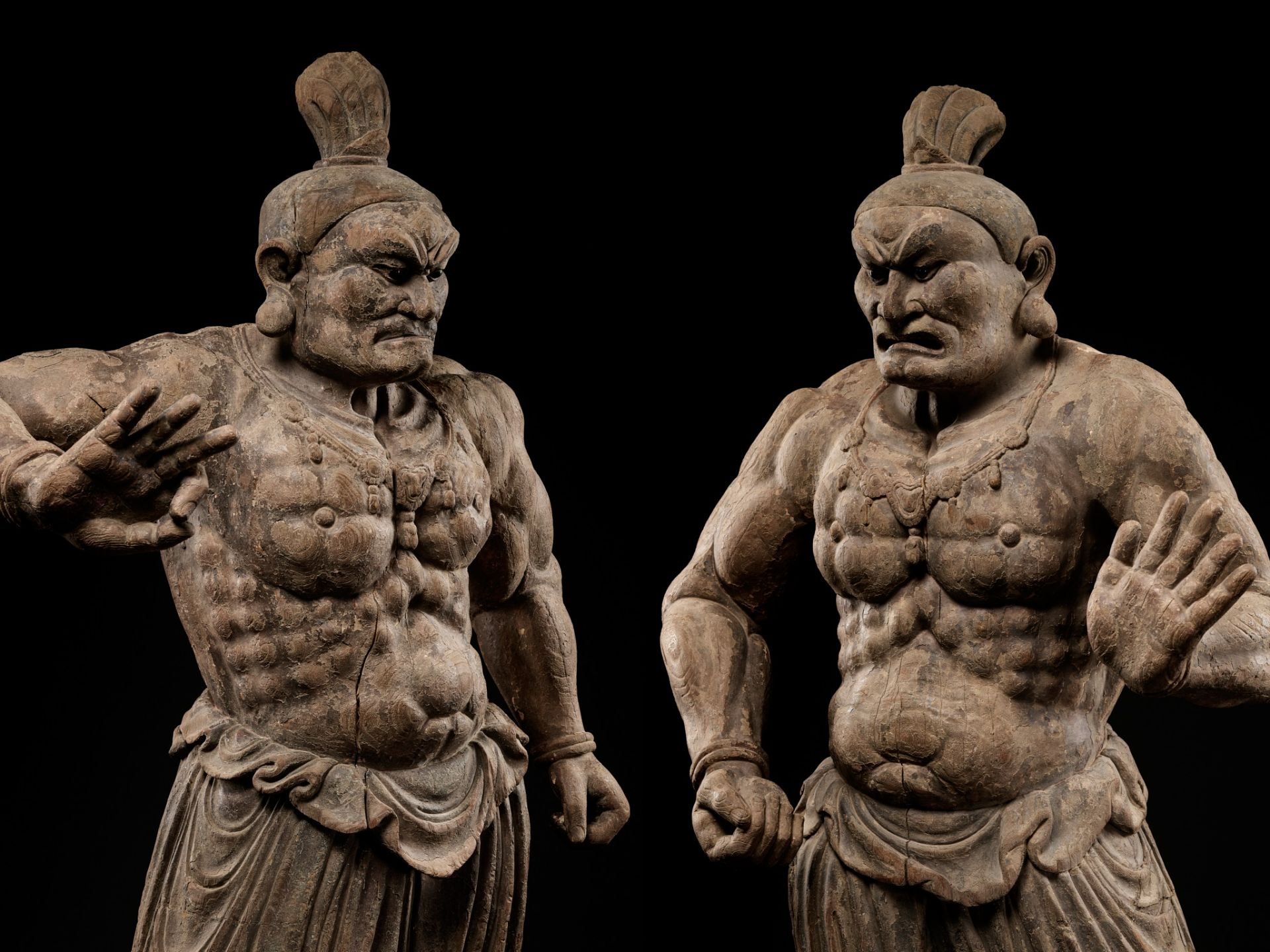 AN EXCEPTIONAL PAIR OF MONUMENTAL WOOD FIGURES OF NIO GUARDIANS